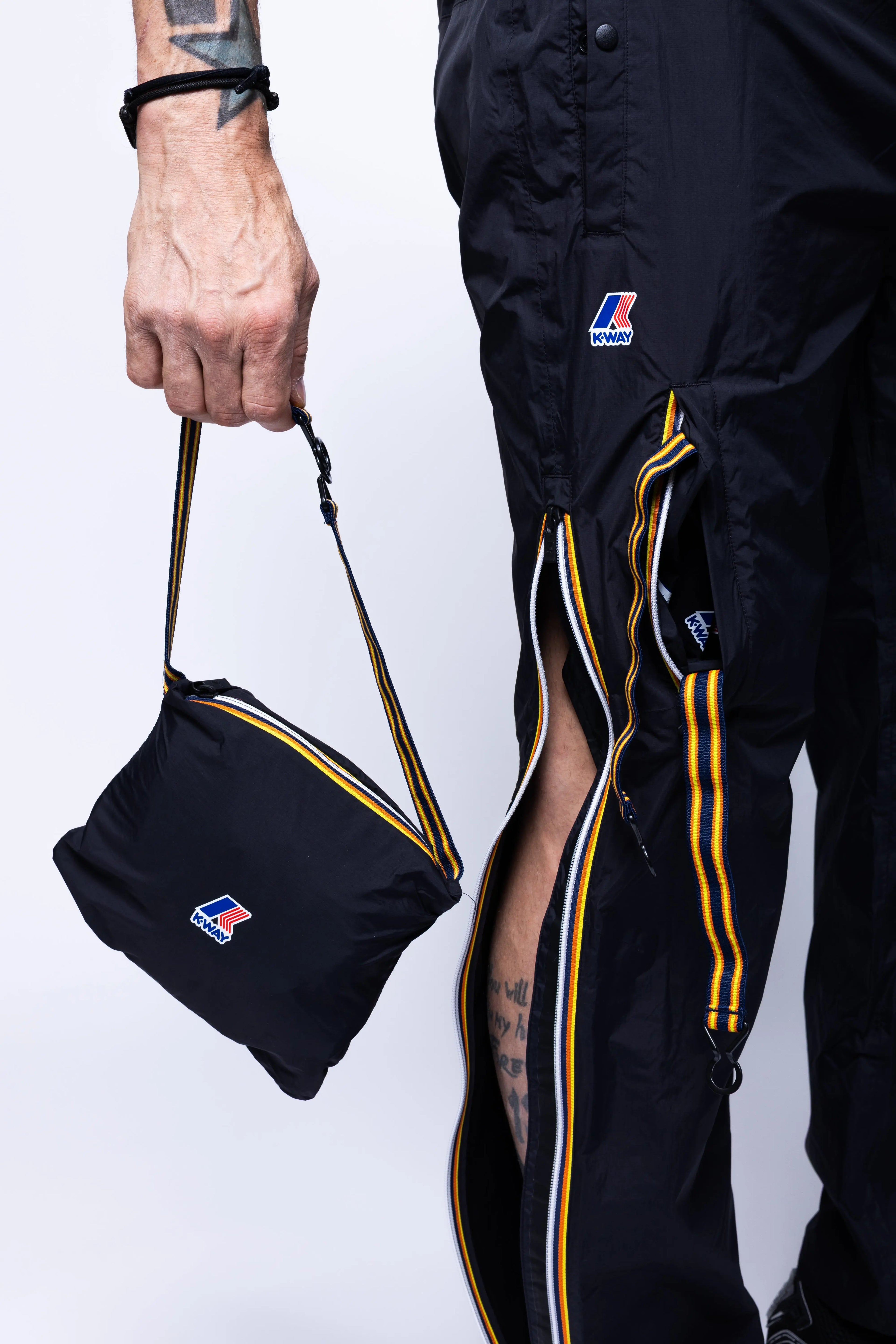 K-Way, Mens Pants, Black, Packable, Elasticated Waistband, Side Pockets, Back Pockets, Waterproof, Windproof, Breathable, Zip Pockets, Leg Zippers, Packet Pants Close-up. 