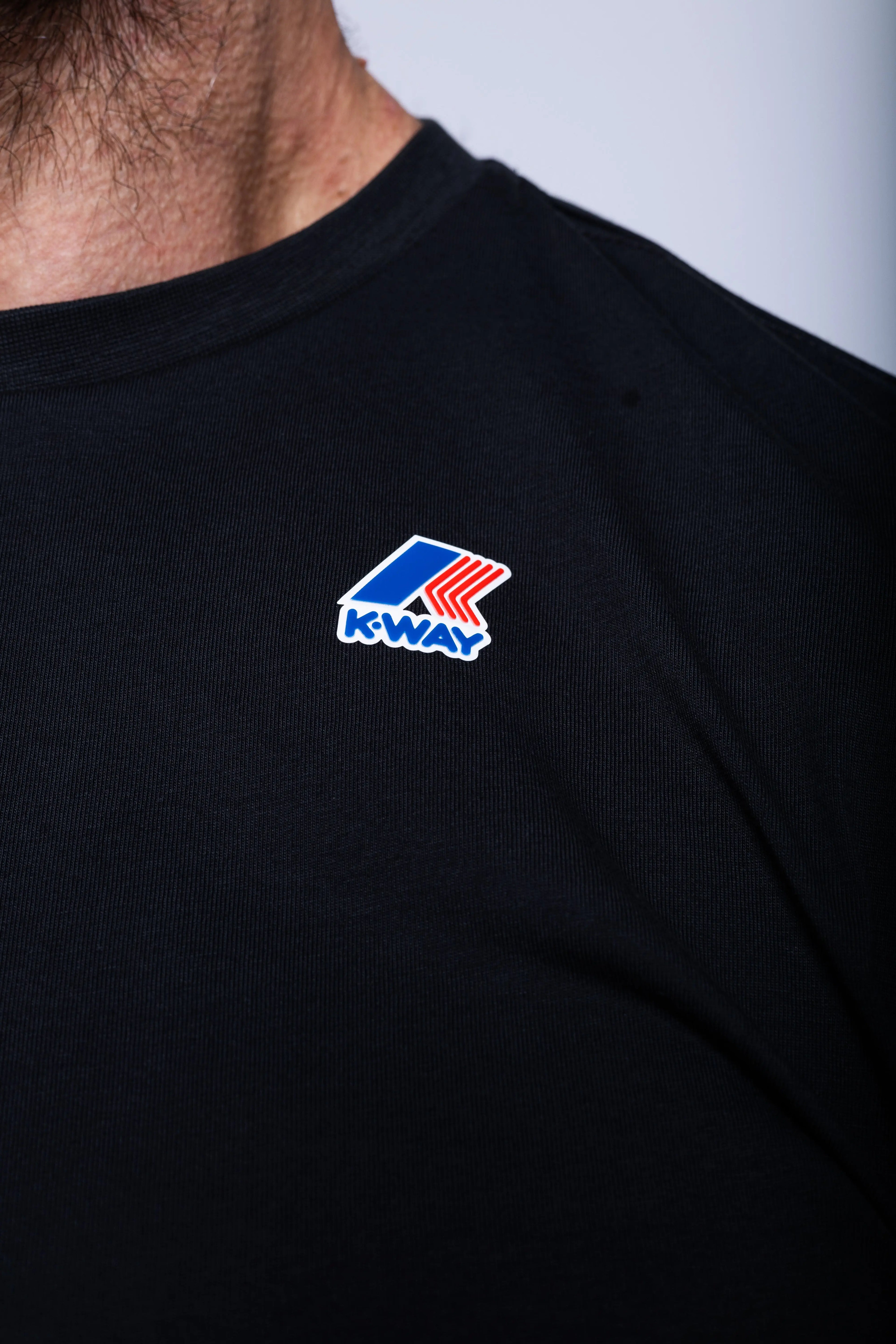 K-Way, Mens T-Shirt, Black, Cotton Jersey, 100% Cotton, Packable, Unisex, Short Sleeves, Zip Bag, Chest Logo, Close-up Chest Logo View. 