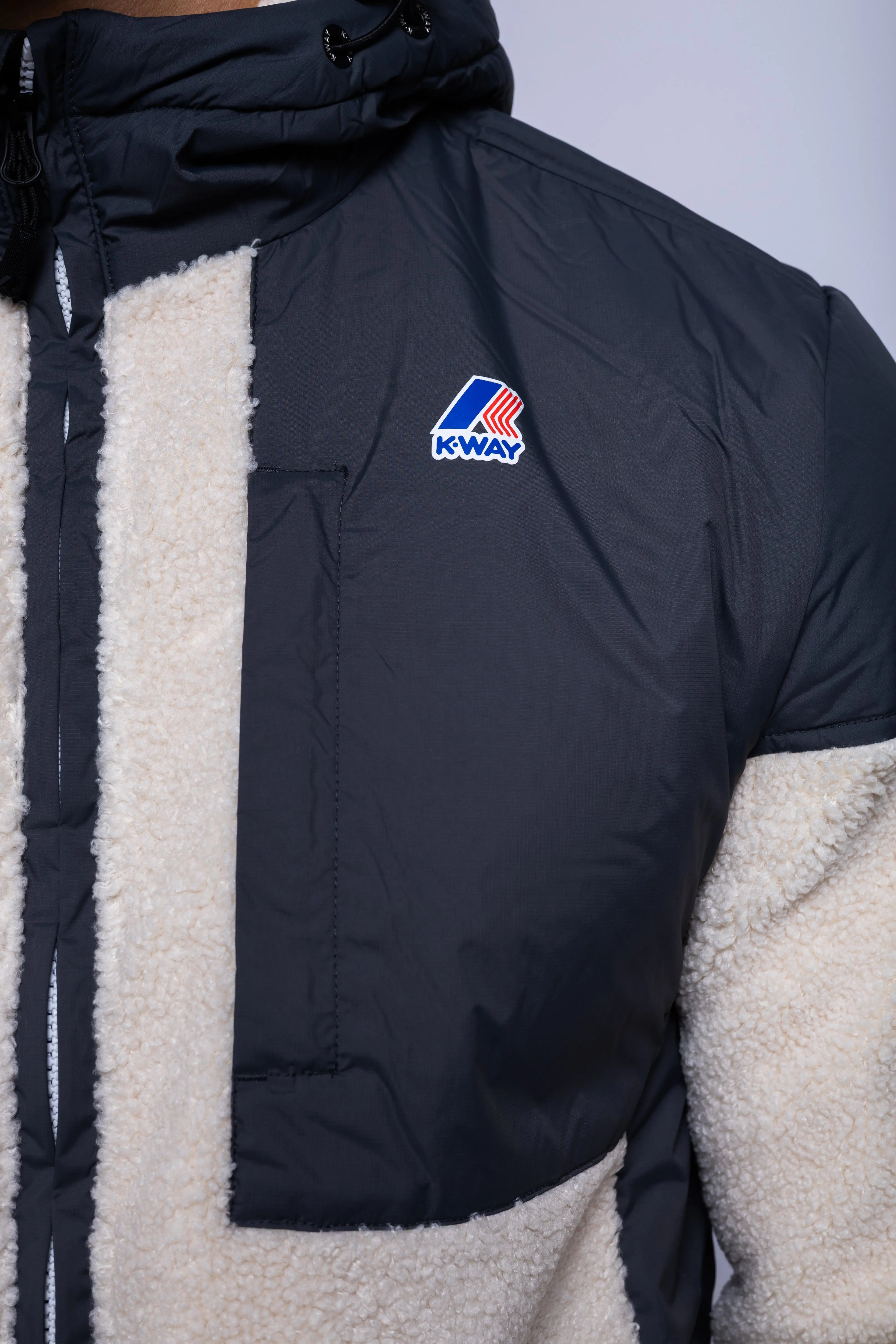 K-Way, Mens Hoodie, Grey Shadow DK-Ecru, Water Proof, Sherpa-Effect Fleece, Micro Ripstop Nylon, Hooded, Jacket, Sweatshirt, Full-Zip, SIde Pockets, Elasticated Cuffs and Hem, Front Pockets, Silicone Logo-Patch, Drawstring Hood, Zip Pockets, Chest Pocket and Logo Close-up. 