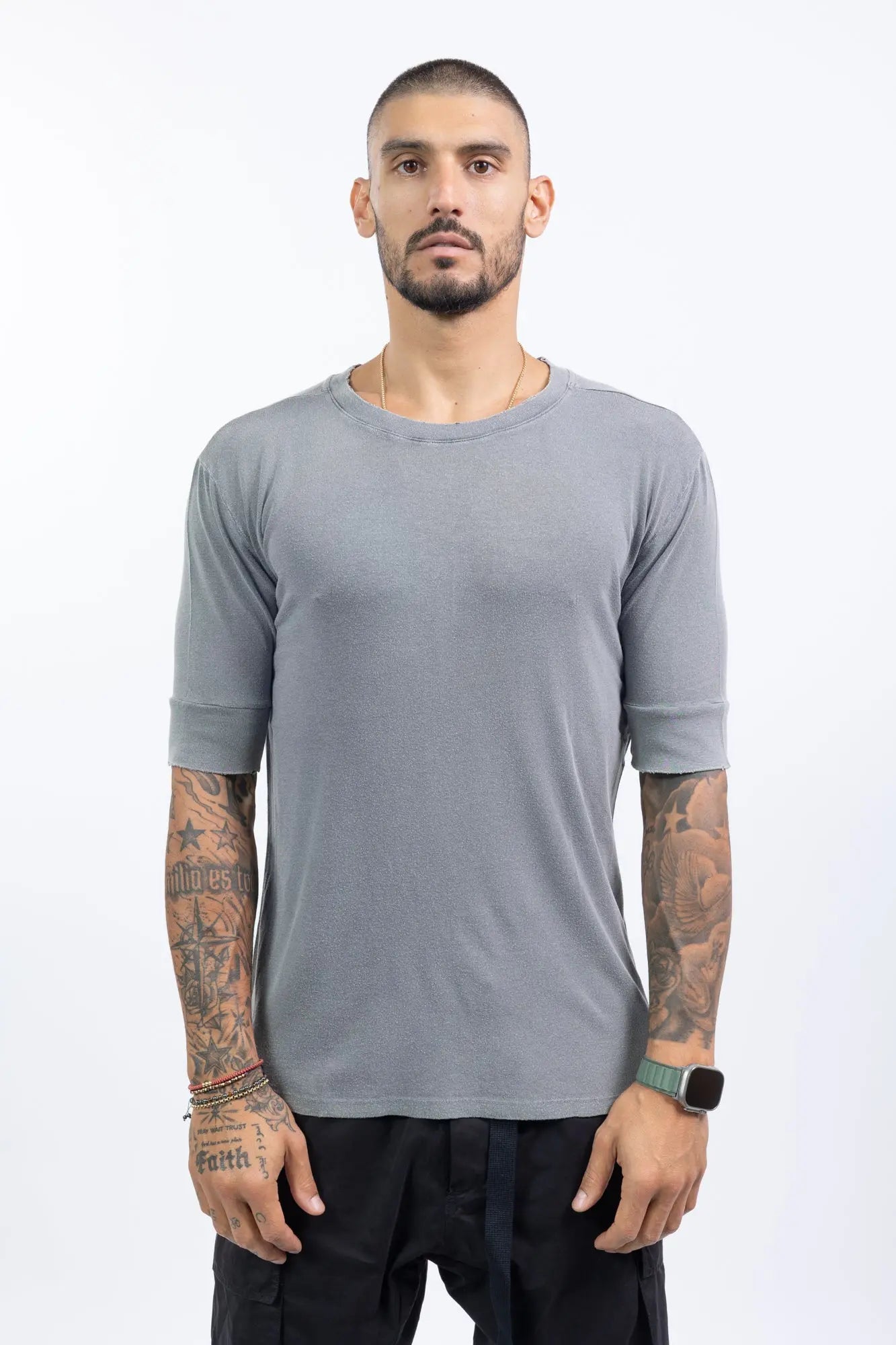 Thom Krom,Mens T-Shirt,Used Grey,Raw Cut Hems,Round  Distressed Crewneck,Straight Hemline,Back Center Seam Detail,Embroidered Logo On The Back,Long Sleeve Cut Detail,Front Portrait.