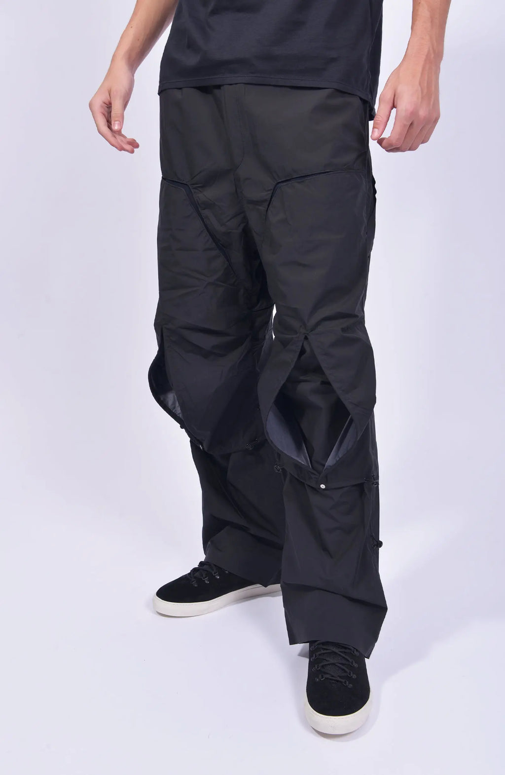 Nilmance, Mens Pants, Black, Ventilation Mesh Inserts, Side Pockets, Double Back Pockets, Elasticated Legs, Elasticated Ankles, Drawcord Waistband, Belt Loops, Elasticated Knee Modules, Snap Fastening Knee Panels, Fully Customizable, Front 3/4 View. 