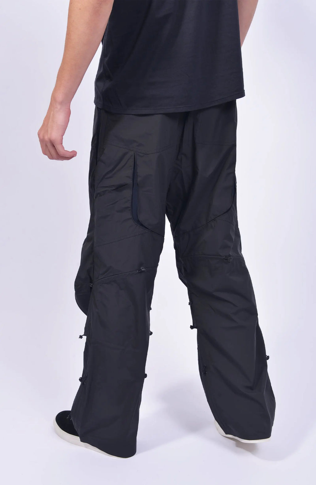 Nilmance, Mens Pants, Black, Ventilation Mesh Inserts, Side Pockets, Double Back Pockets, Elasticated Legs, Elasticated Ankles, Drawcord Waistband, Belt Loops, Elasticated Knee Modules, Snap Fastening Knee Panels, Fully Customizable, Back 3/4 View. 