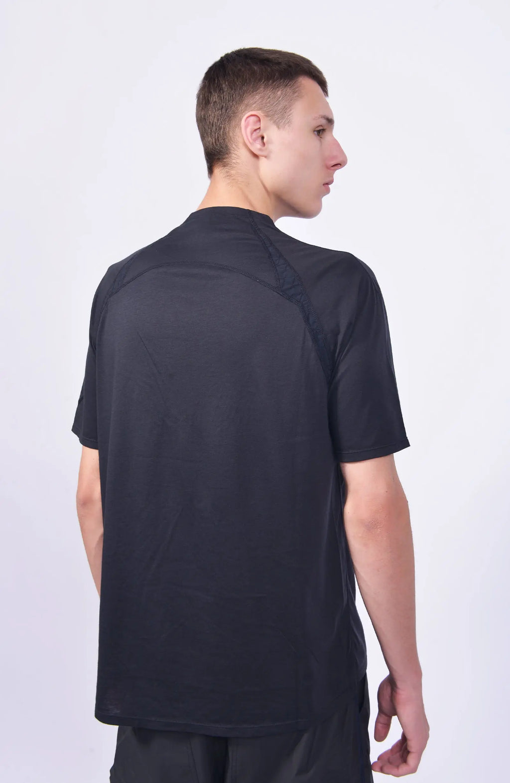Nilmance, Mens T-Shirt, Black, Half-Zip, Breathable Cotton Modal Jersey, UV Protection, Short Sleeves, Mock Neck, Lightweight, Comfortable Jersey, Sun Protection, Back Portait 3/4 View. 