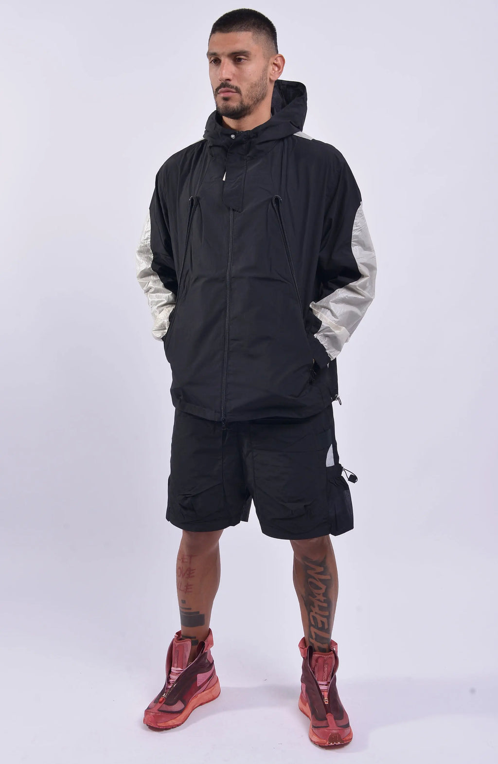 Nilmance, Mens Jacket, Black, Full-Zip, Hooded, YKK Zippers, Side Pockets, Waterproof, Windproof, Water-Repellent, Elasticated Cuffs, Black and White, Zip Pockets, Velcro, Full Body Front 3/4 View. 