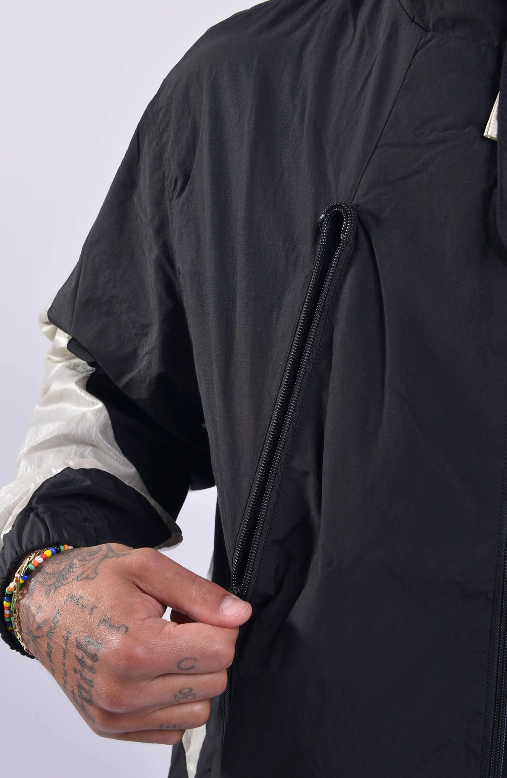 Nilmance, Mens Jacket, Black, Full-Zip, Hooded, YKK Zippers, Side Pockets, Waterproof, Windproof, Water-Repellent, Elasticated Cuffs, Black and White, Zip Pockets, Velcro, Zip Pocket Close-up. 