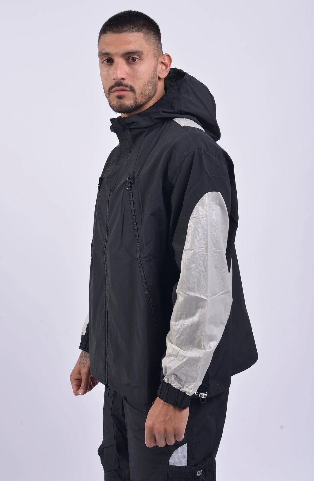 Nilmance, Mens Jacket, Black, Full-Zip, Hooded, YKK Zippers, Side Pockets, Waterproof, Windproof, Water-Repellent, Elasticated Cuffs, Black and White, Zip Pockets, Velcro, Front Portrait 3/4 View. 