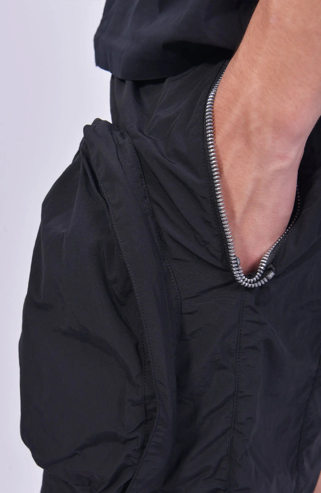Nilmance, Mens Shorts, Black, Large Front pockets, Side Zip Pockets, Elasticated Waistband, Drawstring, Back Pockets, DWR Fabric, Water-Repellent, Waterproof, Loose-fit, Left hand in pocket. 