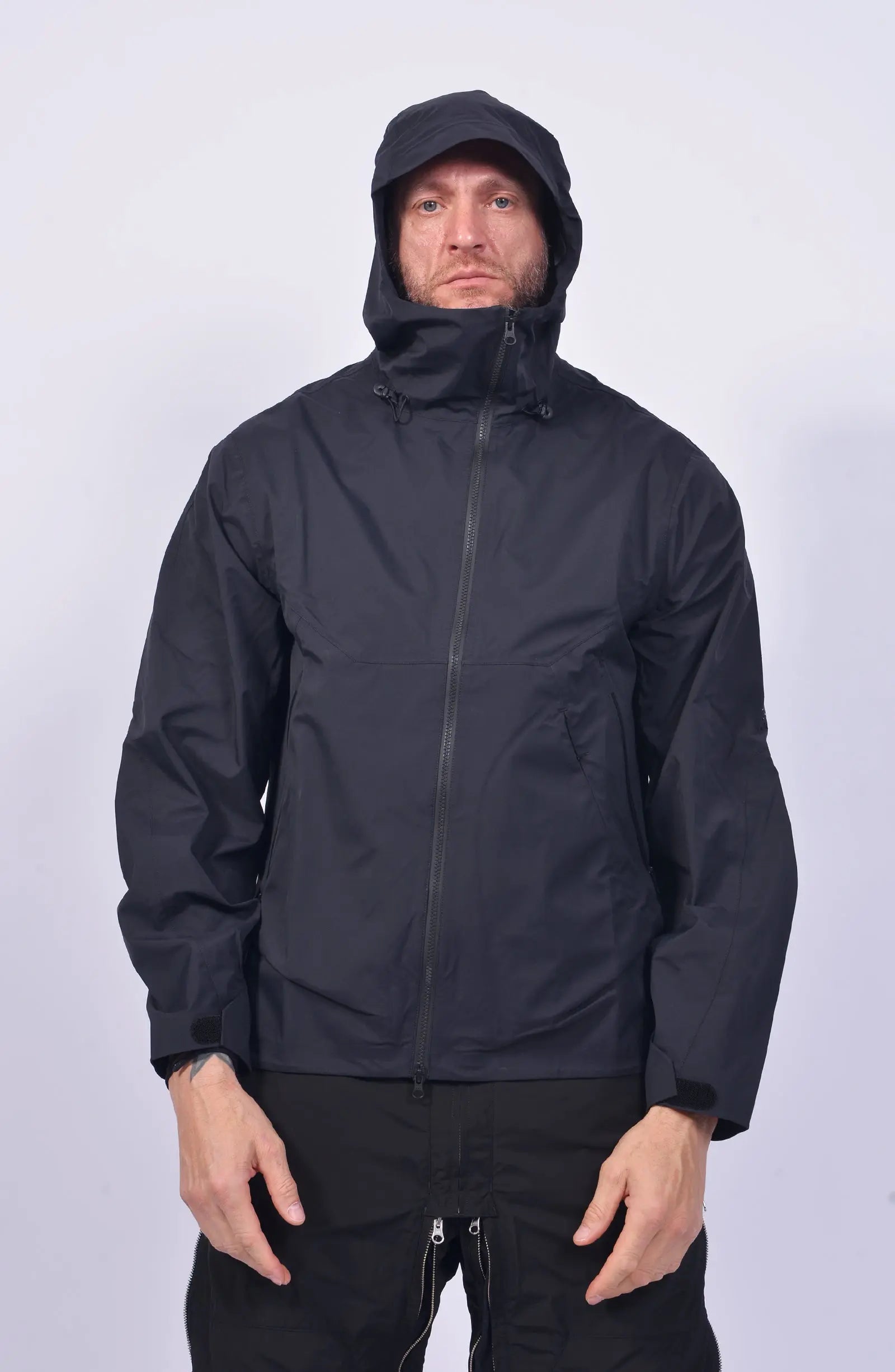 Nilmance, Mens Jacket, Black, Hooded, Waterproof 10k, Water-Repellent, Long Sleeves, Side Pockets, Zip Pockets, Velcro Adjustable Cuffs, Full-Zip, Centre Front Zip Opening, YKK Zippers, Elastic Drawcord, Rear-Adjustable Hood, Laser Cut Holes for Ventilation, Breathable, Hooded Front Portrait. 