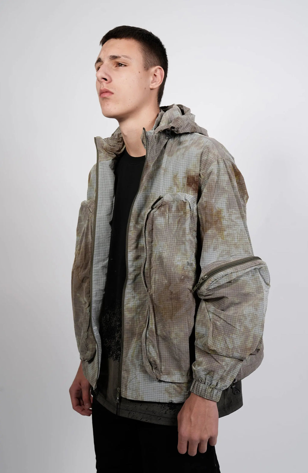 Nilmance, Mens Jacket, Garment Dyed, Grey, Brown, Acid, Cargo Pockets, Side Pockets, Hooded, Drawcord, Elastic Cuffs, Full Zip, Zip Pockets, YKK Zippers, Large Bellows Pockets, Front 3/4 View. 