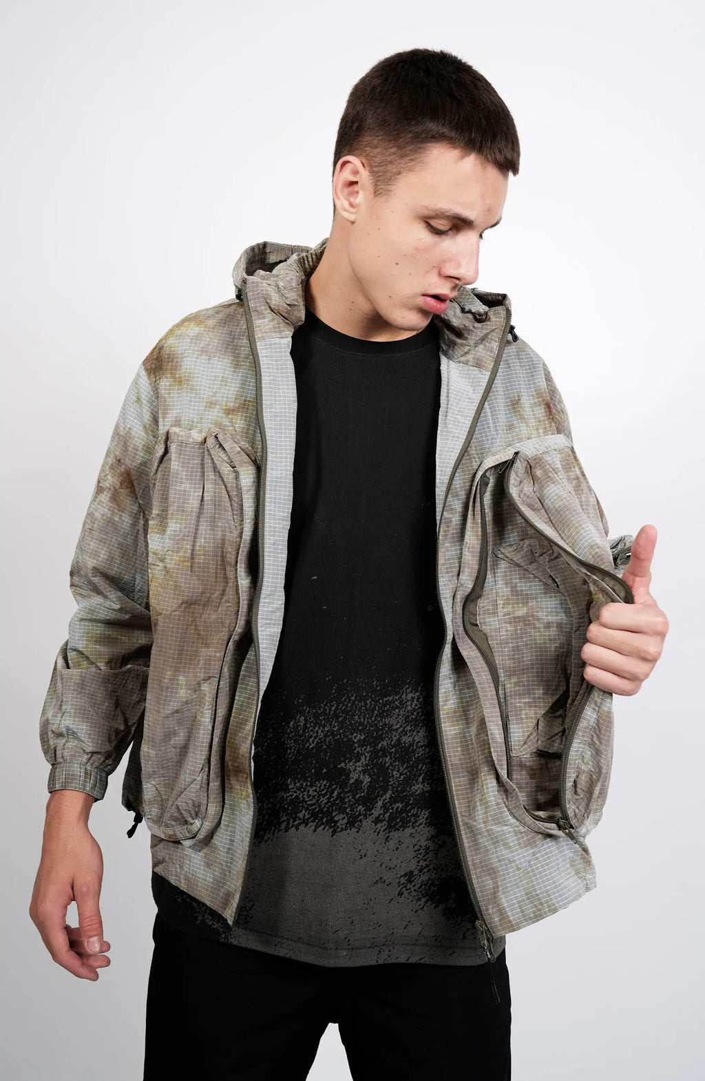 Nilmance, Mens Jacket, Garment Dyed, Grey, Brown, Acid, Cargo Pockets, Side Pockets, Hooded, Drawcord, Elastic Cuffs, Full Zip, Zip Pockets, YKK Zippers, Large Bellows Pockets, Front View Unzipped Holding Pocket Open. 