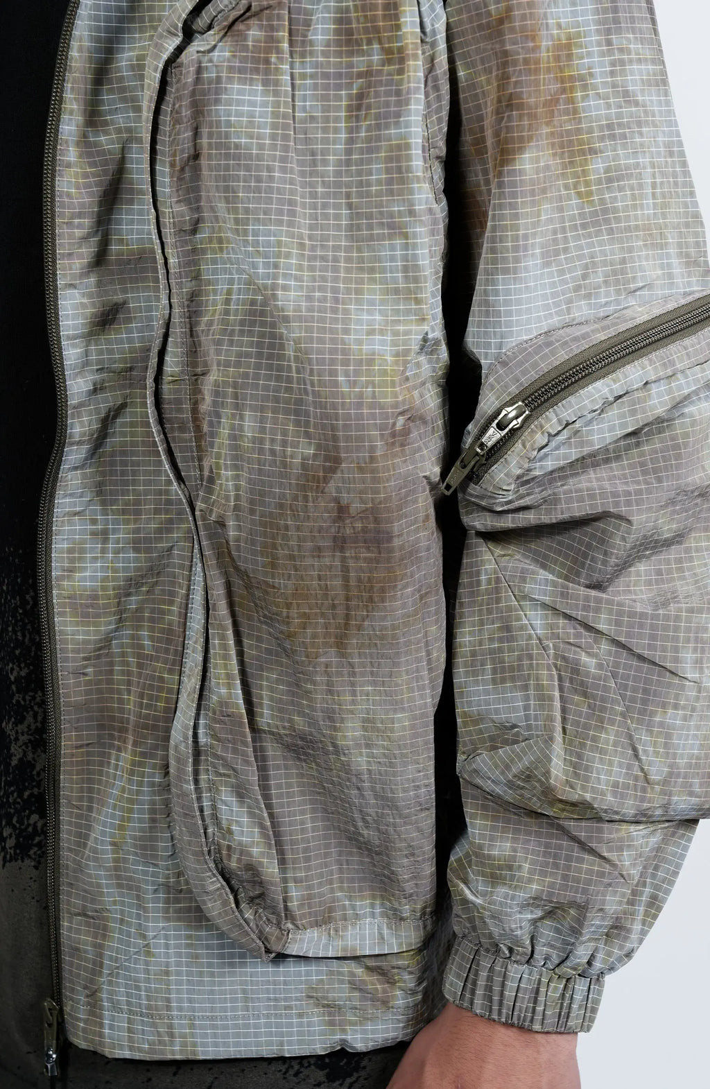 Nilmance, Mens Jacket, Garment Dyed, Grey, Brown, Acid, Cargo Pockets, Side Pockets, Hooded, Drawcord, Elastic Cuffs, Full Zip, Zip Pockets, YKK Zippers, Large Bellows Pockets, Front Pockets and Elbow Zipper Showcase. 