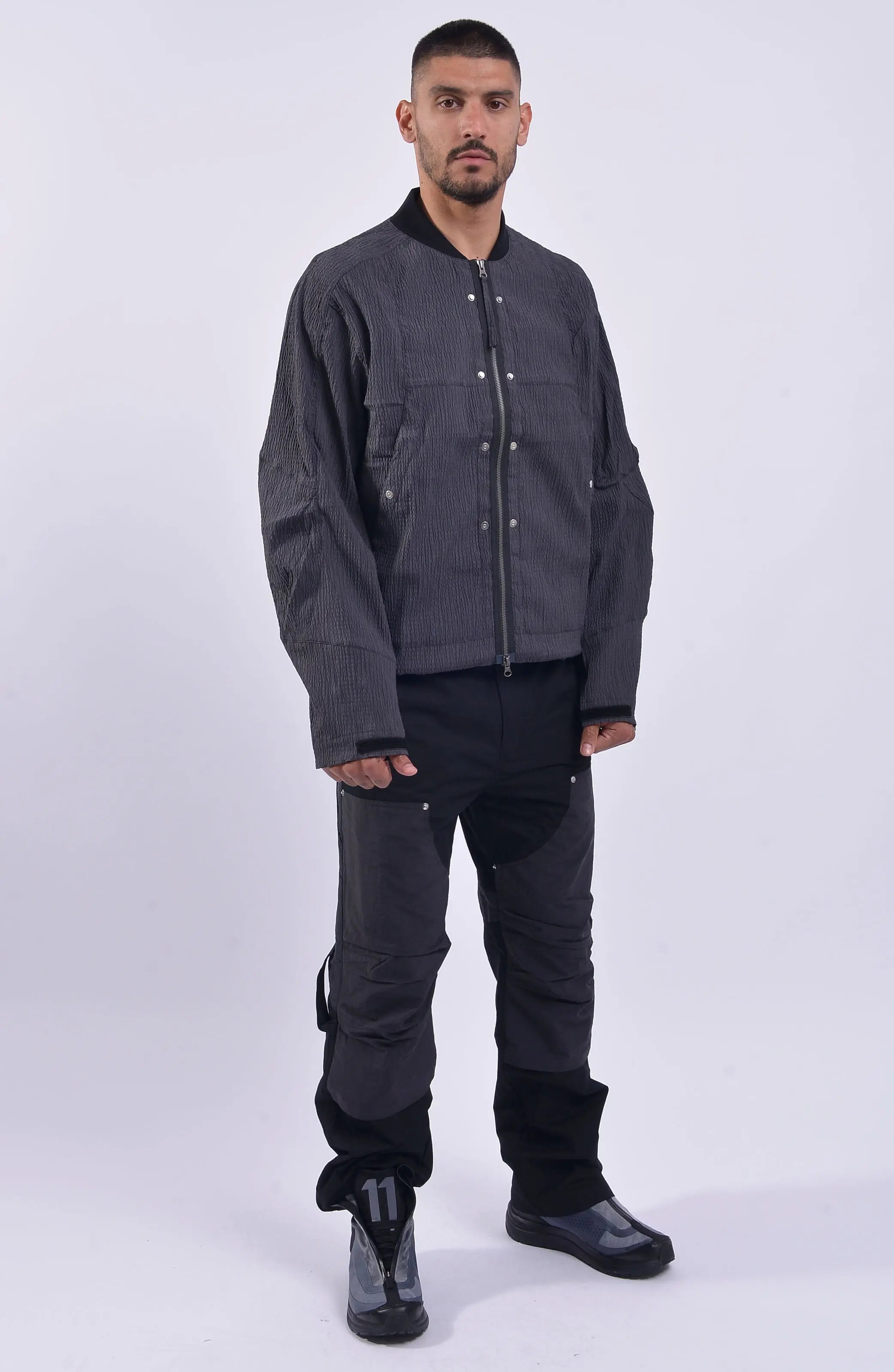 Nilmance, Mens Bomber Jacket, Grey, Black, Reversible, Water-Repellent, Centre Zip Closure, Full-Zip, Lining Zip, Vest Lining, Long Sleeves, Adjustable Cuffs, Velcro, YKK Zippers, Side Zip Pockets, Round Neck, Snap Fastening, Chest Pockets, Full Body Front 3/4 View. 