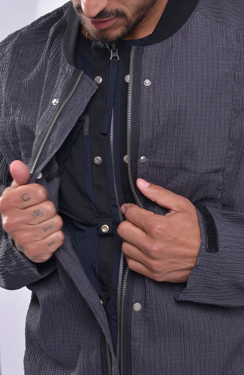 Nilmance, Mens Bomber Jacket, Grey, Black, Reversible, Water-Repellent, Centre Zip Closure, Full-Zip, Lining Zip, Vest Lining, Long Sleeves, Adjustable Cuffs, Velcro, YKK Zippers, Side Zip Pockets, Round Neck, Snap Fastening, Chest Pockets, Shell Opening Inside Peek Close-up. 