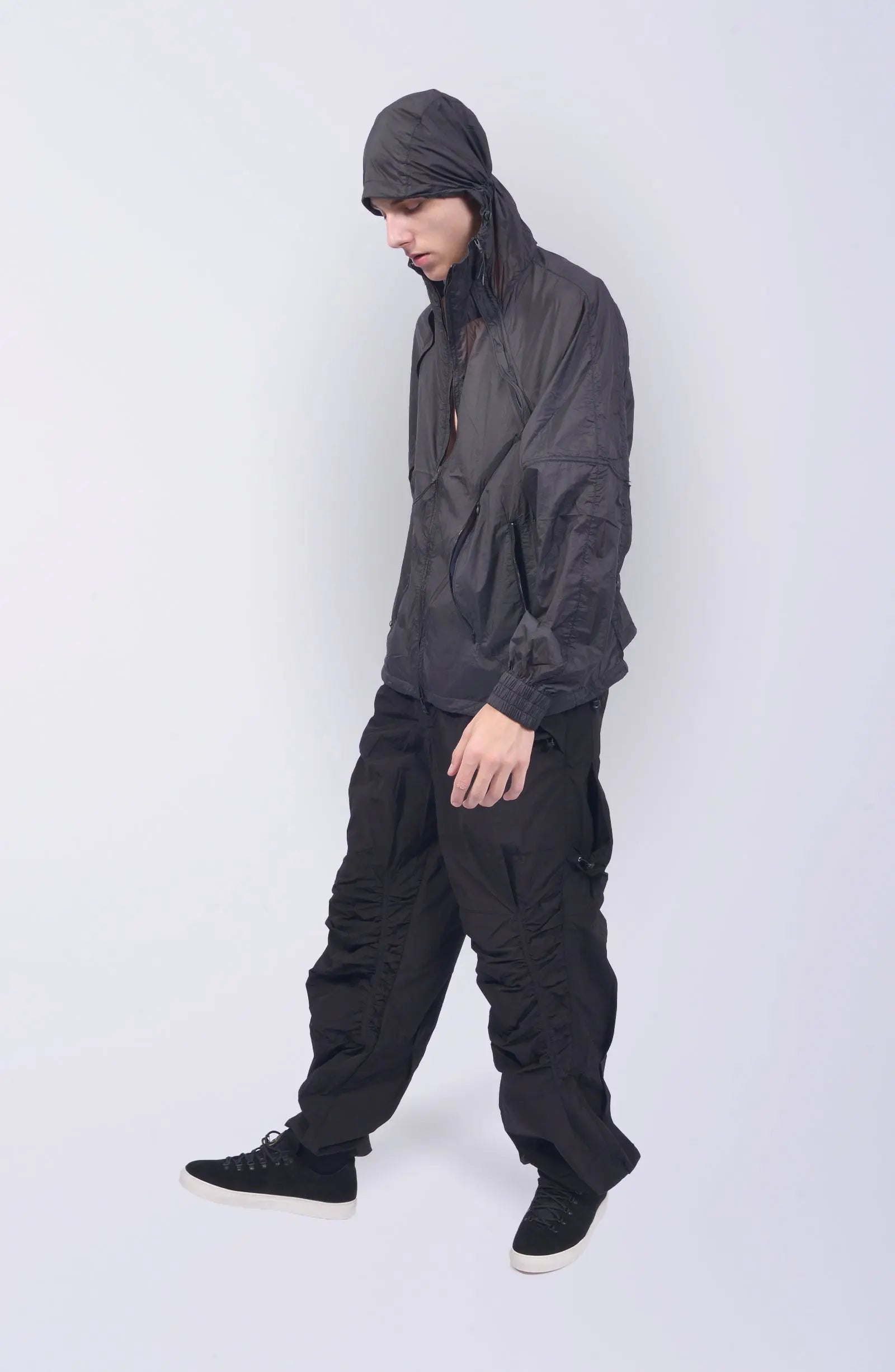 Nilmance, Mens Jacket, Transparent, Light Grey, Gray, Full Zip, Zip Ventilation Openings, Elasticated Cuffs, Cinch Hood, Drawcord Hood, Side Zip Pockets, Lightweight, Windproof, Full Body Front 3/4 View in-motion. 