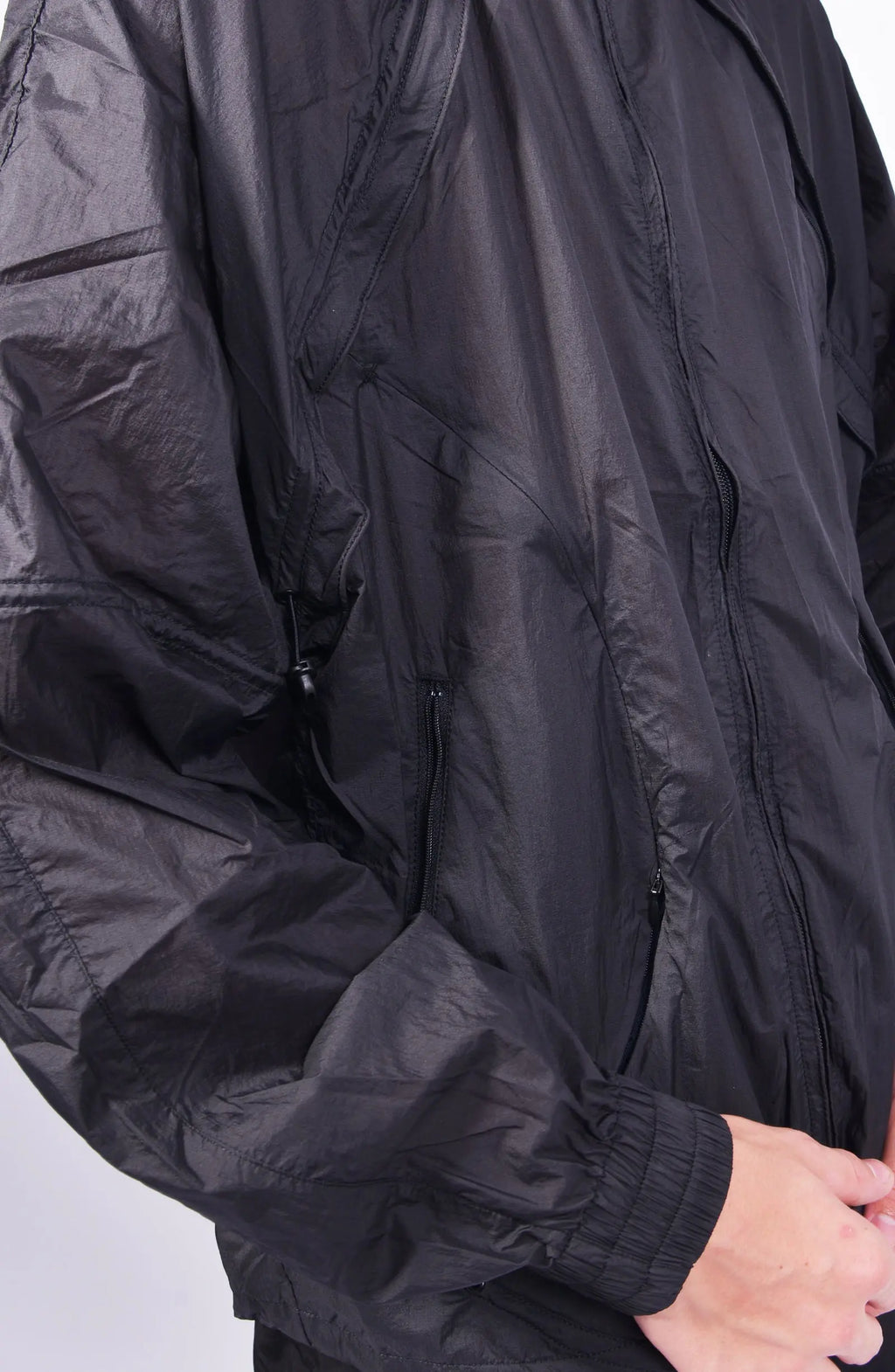 Nilmance, Mens Jacket, Transparent, Light Grey, Gray, Full Zip, Zip Ventilation Openings, Elasticated Cuffs, Cinch Hood, Drawcord Hood, Side Zip Pockets, Lightweight, Windproof, Side Pockets and Sleeve fit Close-up. 