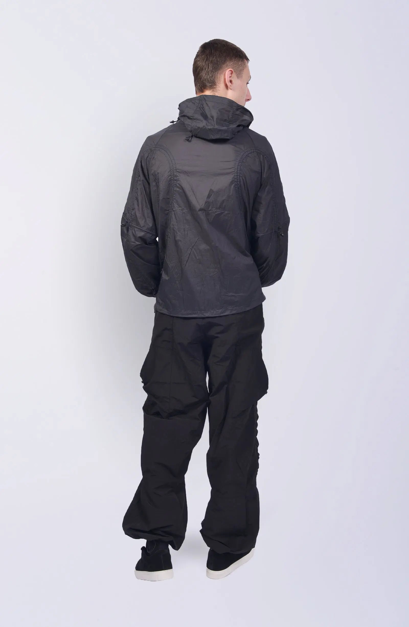 Nilmance, Mens Jacket, Transparent, Light Grey, Gray, Full Zip, Zip Ventilation Openings, Elasticated Cuffs, Cinch Hood, Drawcord Hood, Side Zip Pockets, Lightweight, Windproof, Full Body Back View. 