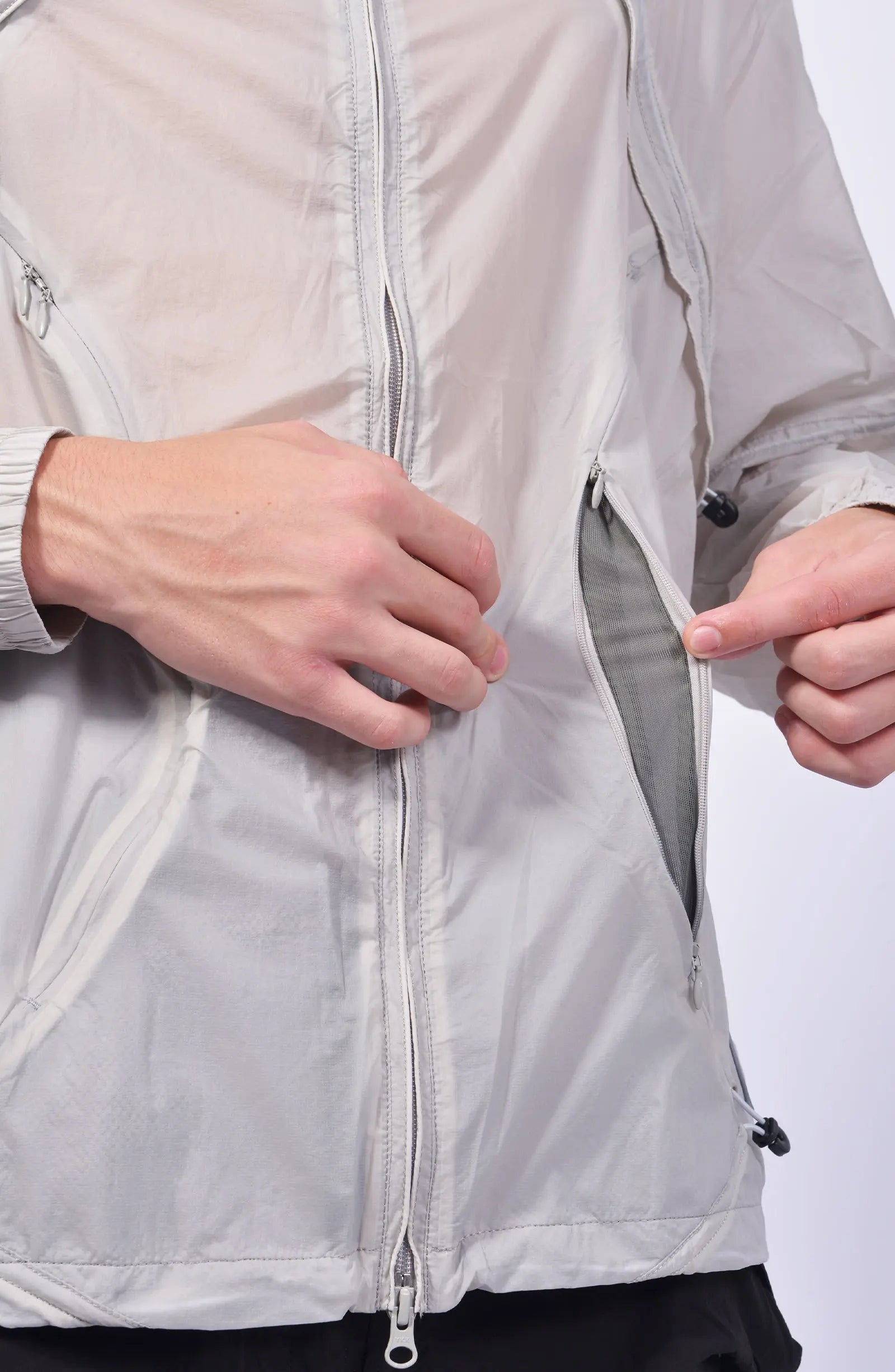 Nilmance, Mens Jacket, Transparent, Light Grey, Gray, Full Zip, Zip Ventilation Openings, Elasticated Cuffs, Cinch Hood, Drawcord Hood, Side Zip Pockets, Lightweight, Windproof, Zip Ventilation Opening Close-up. 