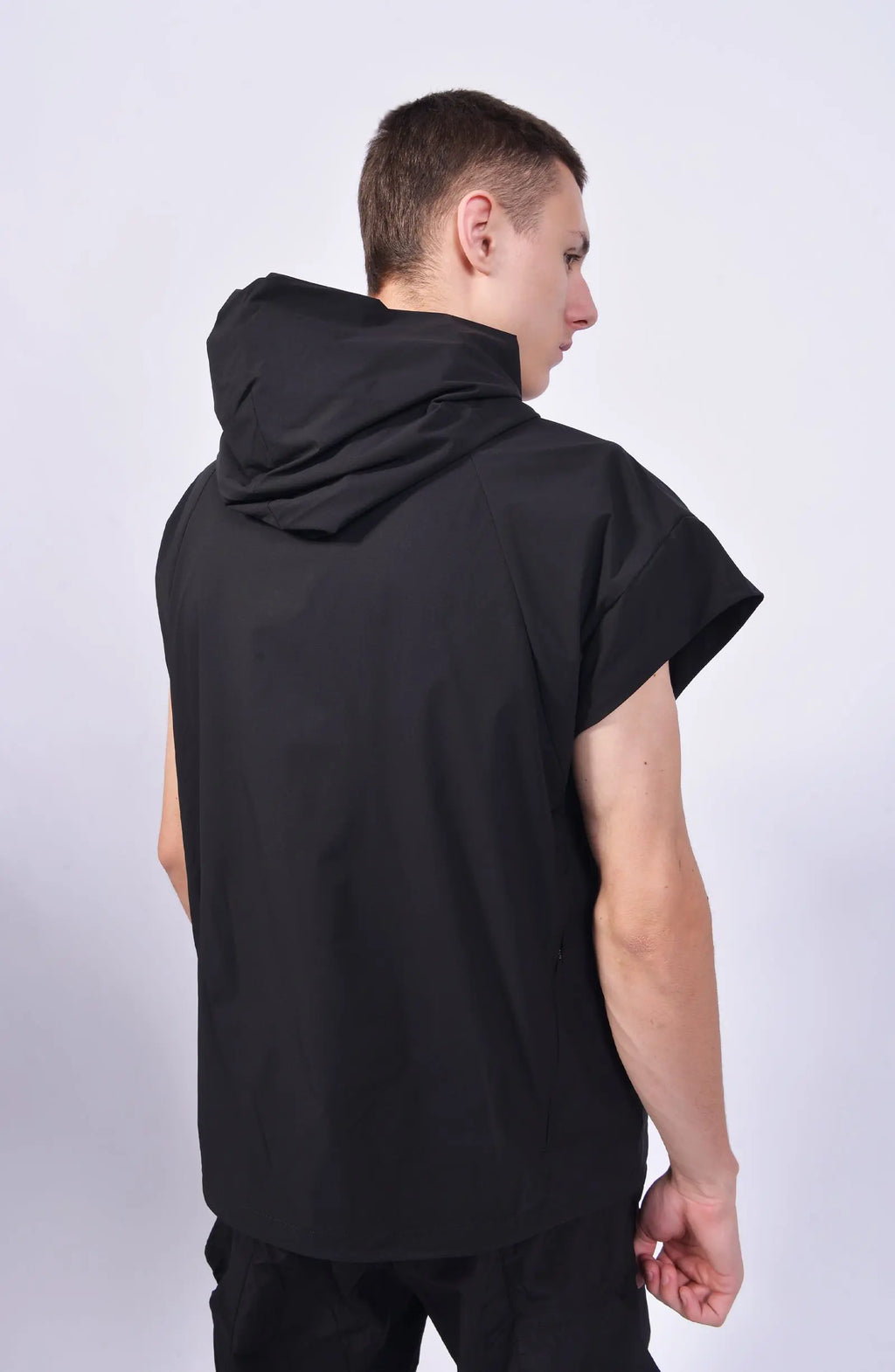 Nilmance, Mens Vest, Black, Hooded, Breathable by design, Elastic Fabric, Solotex, Comfortable, Sleeveless, Symmetric Panel Construction, Back 3/4 Portrait View. 