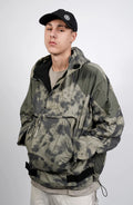 Nilmance, Mens Jacket, Green Camo, Elastic Concealed Drawcord Hood and Hem, Velcro Adjustable Cuffs and Hood, Large Front Zip Pocket, YKK Zippers, Ripstop Nylon, Water-repellent treated, Front 3/4 Portrait View. 