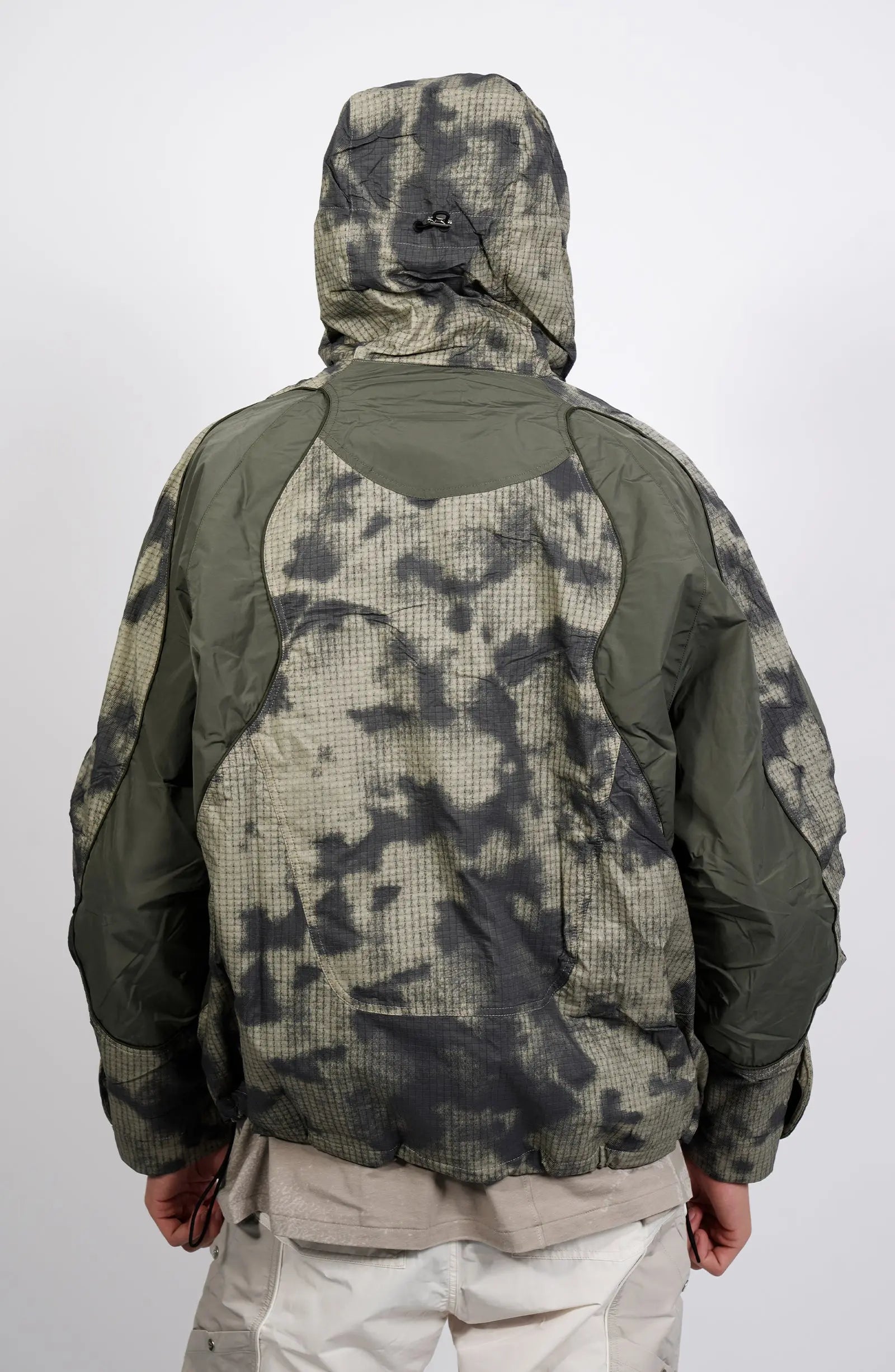 Nilmance, Mens Jacket, Green Camo, Elastic Concealed Drawcord Hood and Hem, Velcro Adjustable Cuffs and Hood, Large Front Zip Pocket, YKK Zippers, Ripstop Nylon, Water-repellent treated, Back Portrait Hooded. 
