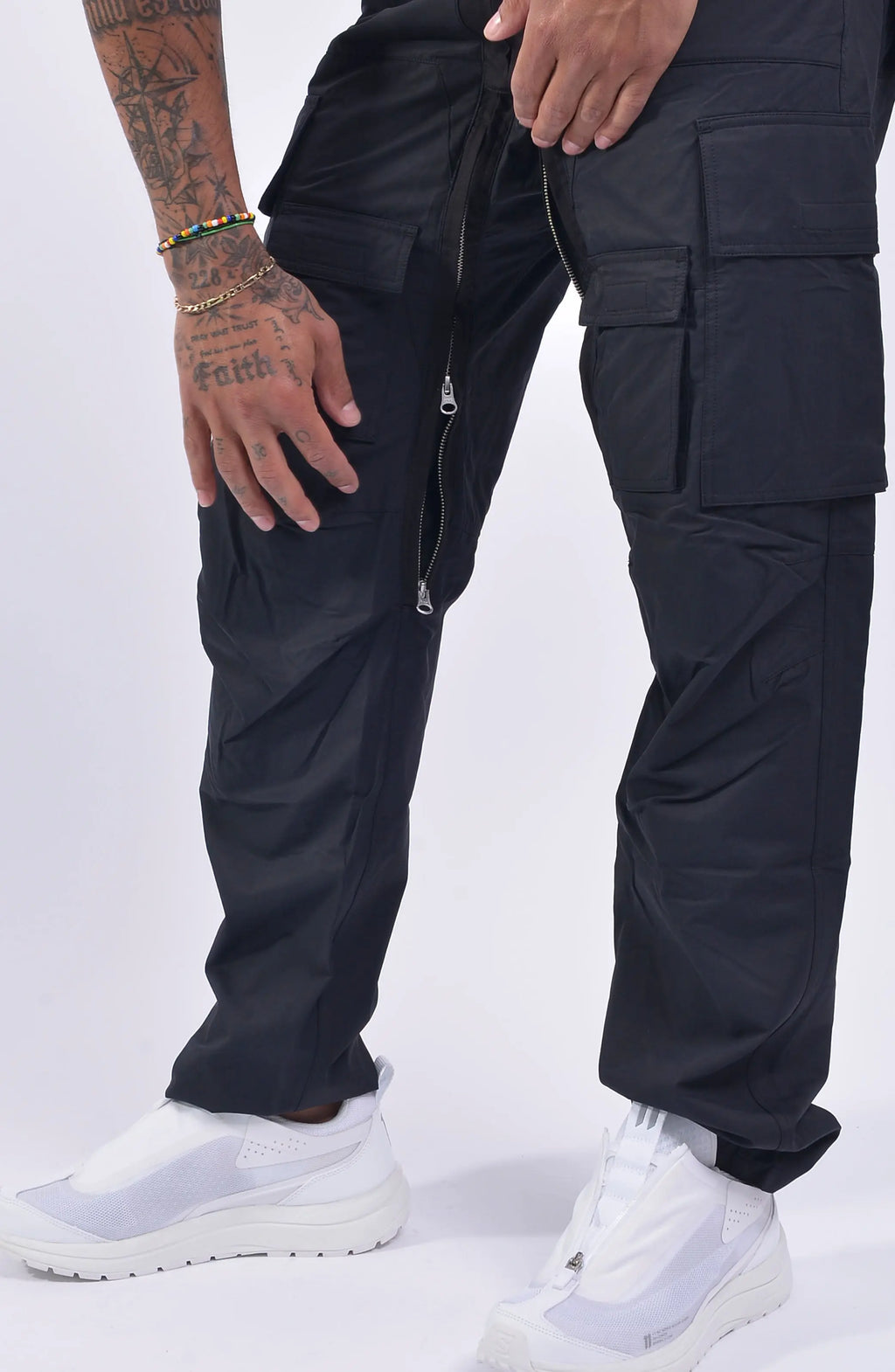 Nilmance, Mens Trousers, Black, Cargo Pockets, Water Repellent, Nylon Cotton Blend, Zipper Details, Wide Fit, Straight Leg, Side and Front Pockets, Belt Loops, Zip Fly, YKK Zippers, Ventilation Opening, Snap Fastening, Inside Leg Fit Close-up. 