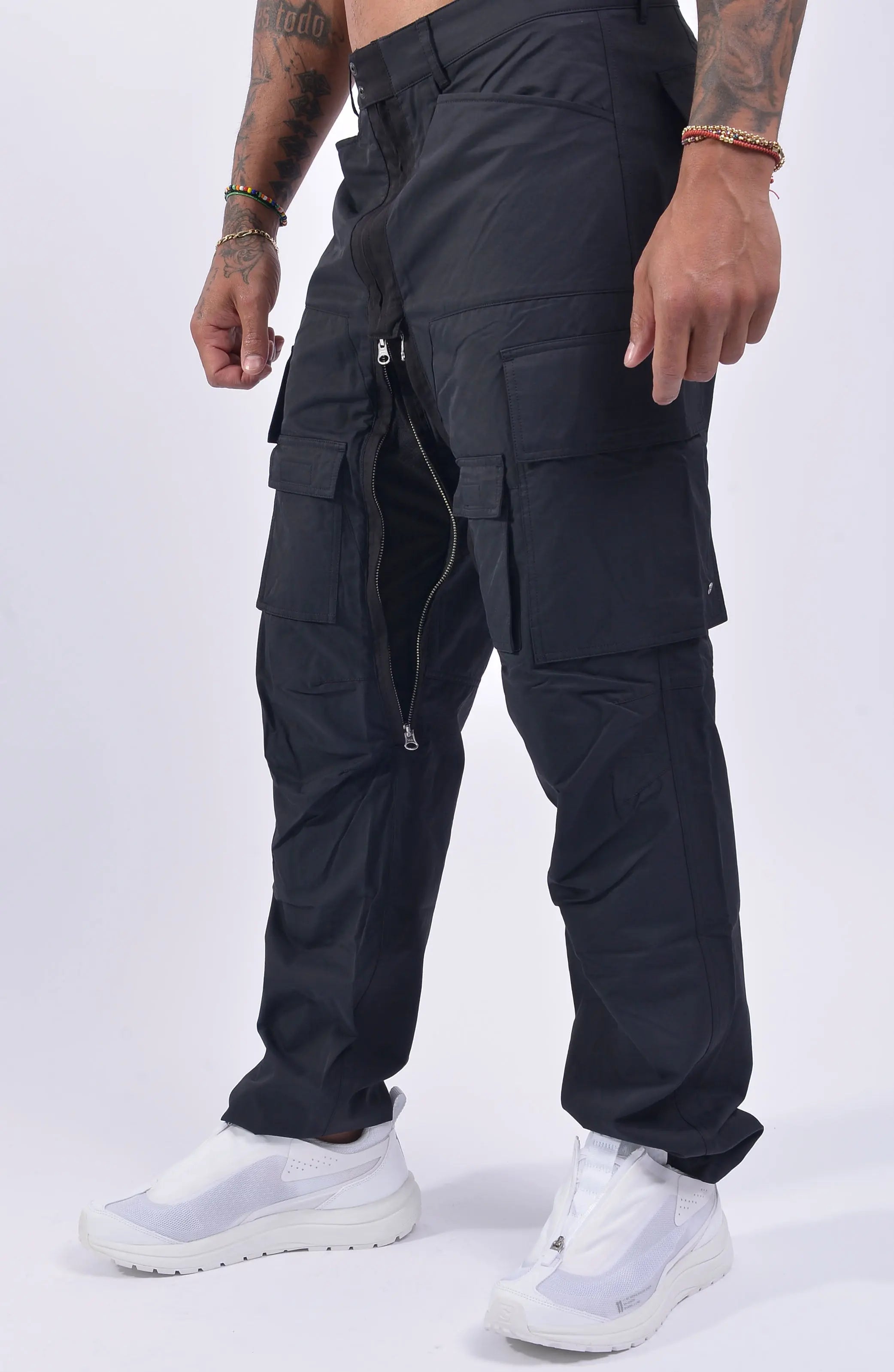 Nilmance, Mens Trousers, Black, Cargo Pockets, Water Repellent, Nylon Cotton Blend, Zipper Details, Wide Fit, Straight Leg, Side and Front Pockets, Belt Loops, Zip Fly, YKK Zippers, Ventilation Opening, Snap Fastening, Portrait Front 3/4 View. 