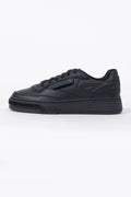 Reebok, Mens Sneakers, Black, Full Leather, Low-Cut Design, Rubber Outsole, Cushioned EVA Midsole, Reebok Club C LTD SS26, Leather U.K. Details, Wimbledon Sneaker, Tennis Court, Grass, Racket, Wilson, Head, Side View. 