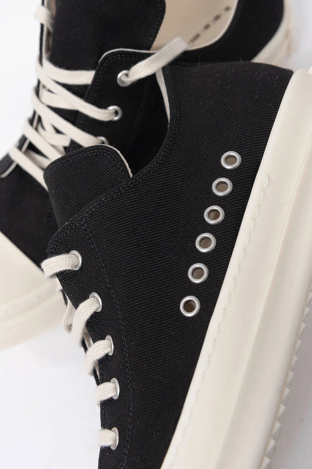 Rick Owens DRKSHDW, Mens Sneakers, Black Milk, Denim Sneakers with Rubber Soles, Signature Cunt Lettering at Heels, Lace-up low top, White Rubber, DRKSHDW Lettering on insoles, Breathability Holes, Side Close-up View. 