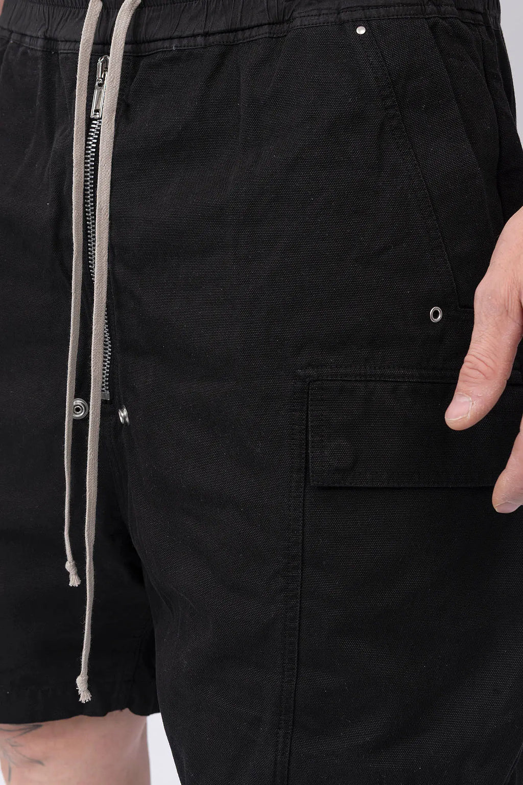 Rick Owens,Mens Shorts,Knee Lenght,Low Crotch,Wide Leg,Elastic Waistband With Drawstrings,Bela Exposed Center Zipper With Two Snap Detail,Two Side Beveled Cargo Pockets With Concealed Snaps And Topstitching , Two Rear Welt Pockets With Concealed Snaps And Topstitching, Lightweight Wash Milk Denim,Black And Natural 8OZ Denim,Dyed,Waxed By Hand,Detailed View Of The Cargo Pocket.