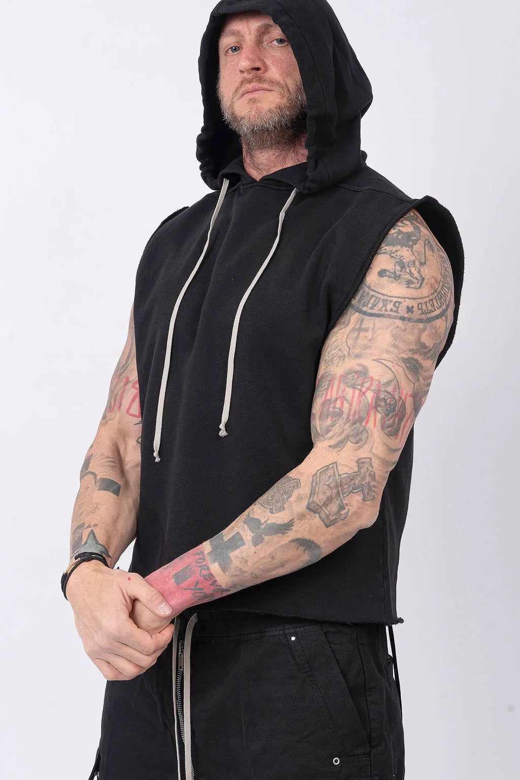 Rick Owens, Mens Temple Tunic,Hip Length,Sleeveless,Black Furka Heavy Sweatshirt Jersey,Large Hood With Drawstrings,Wide Square Body,Garment Dyed,GOTS Certified Organic Cotton,Side Portrait.