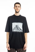 Rick Owens DRKSHDW Mens  T-Shirt , Jumbo Short Sleeve T-Shirt , Pyramid Graphic Print On Front  , Oversized Fit , Ribbed Crewneck , Below Hip Lenght , Elbow Lenght Short Sleeves , Signature Front Level Shoulder Seams , Temple of Love OWENSCORP Print , Black Heavy Cotton , Organic Cotton , Half Body Photo