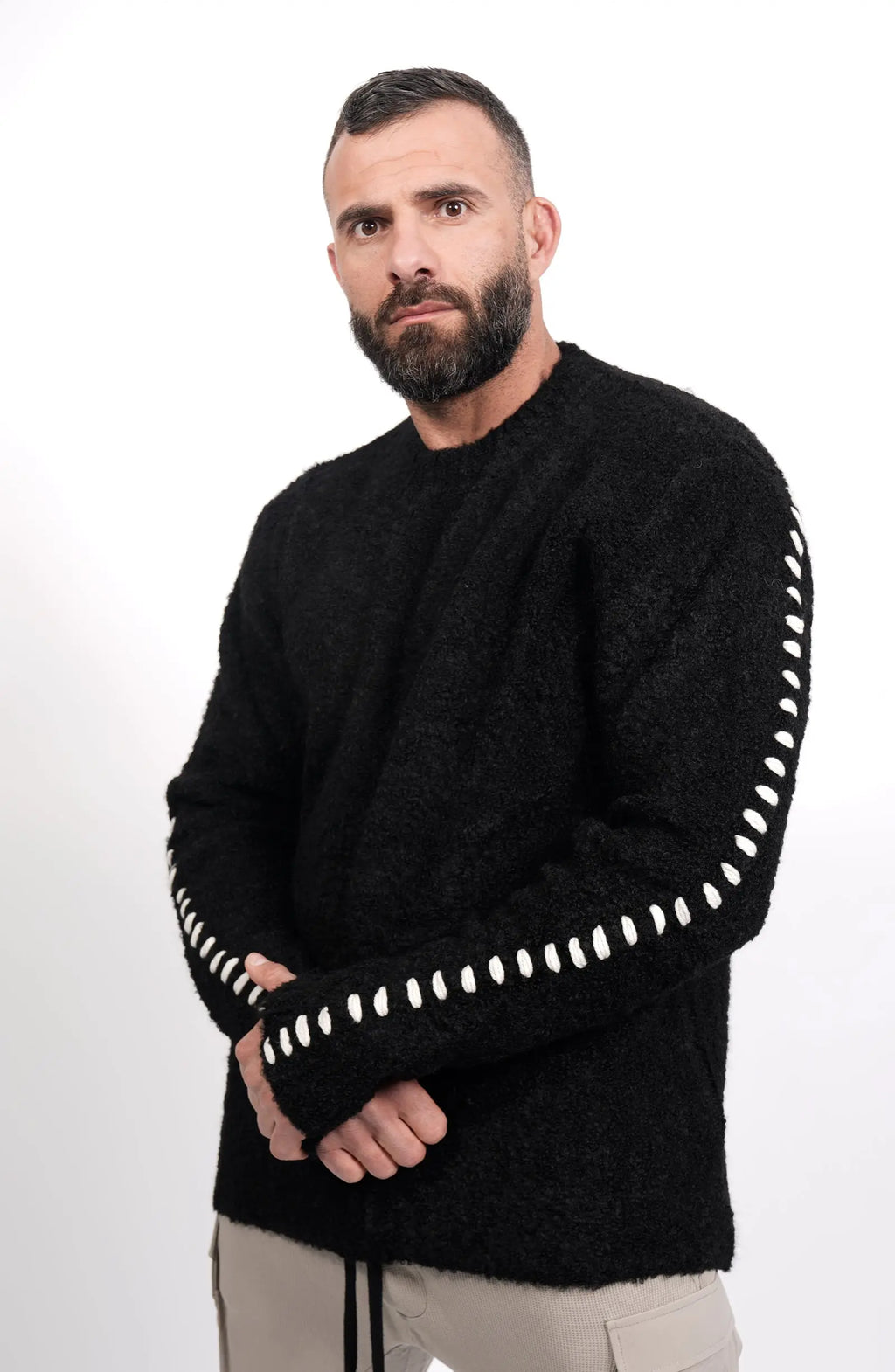 Thom Krom, Mens Sweater, Black, Contrasting White Details, Cross White Stitching, Alpaca Wool, Polyamide, M K 117, Thermal, Warm, Heating, Long Sleeves, Breathable, Front 3/4 View Holding Hands. 