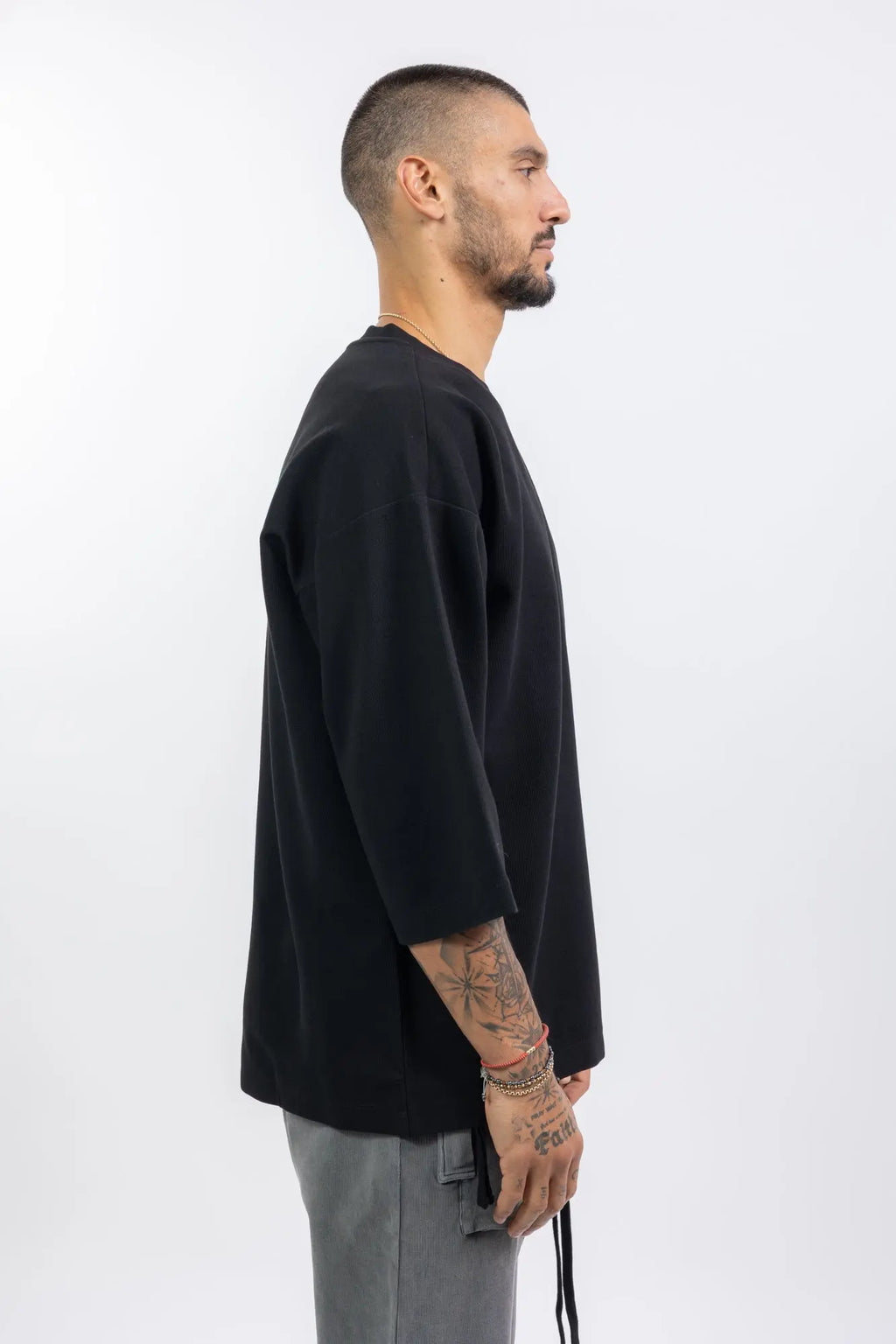 Thom Krom,Mens T-Shirt,Black,Oversized Fit,Rib Knit Crewneck,Dropped Shoulders,Logo Embroidery On The Back,Wide Sleeves Design,Profile Photo.