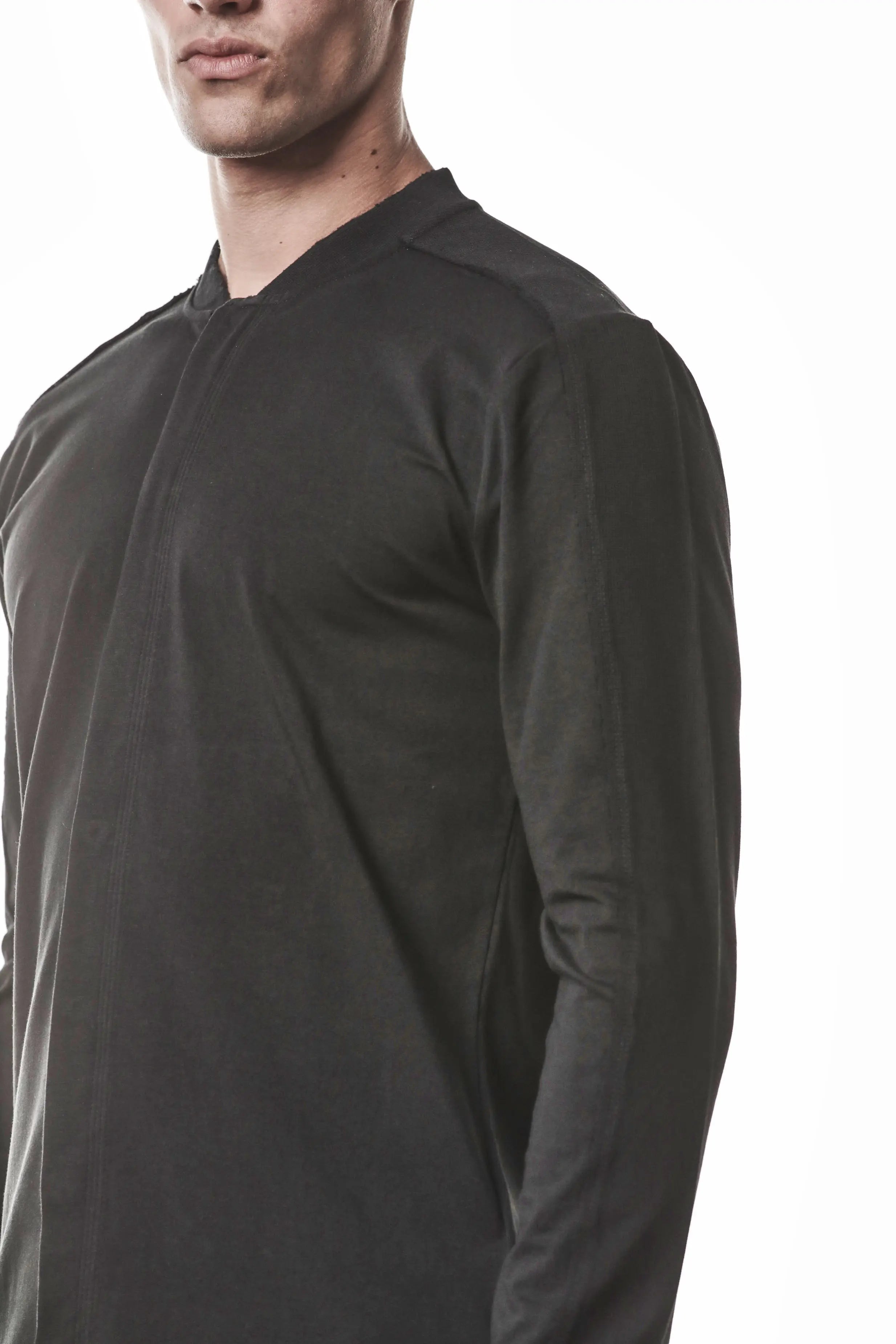 Thom Krom, Mens Shirt, Black, Stretch Sleeves, Exposed Seams, Stitched Logo, Thom/Krom, The Night is your friend, my love, Long Sleeves, Ribbed Collar, Front 3/4 View Close-up. 