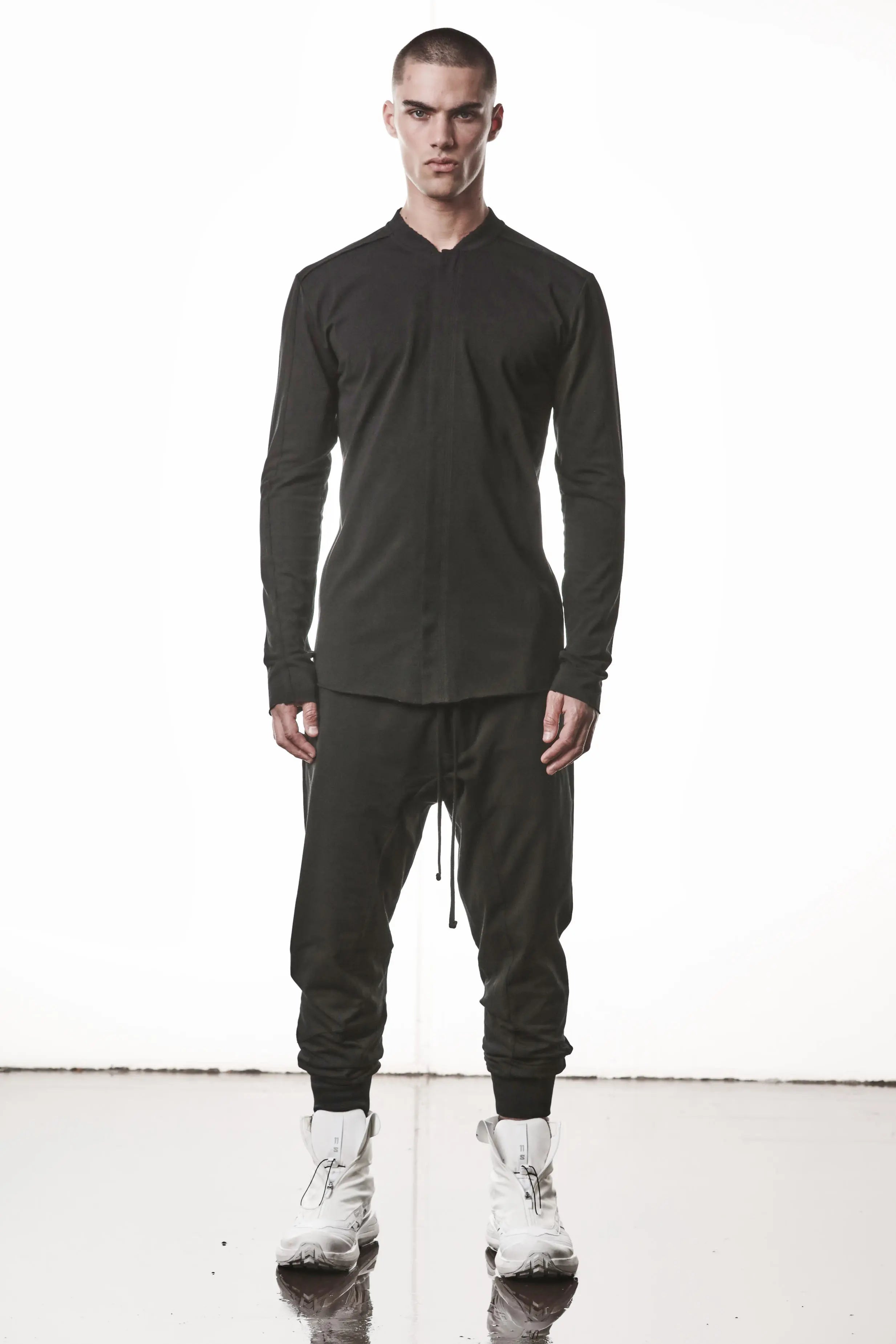 Thom Krom, Mens Shirt, Black, Stretch Sleeves, Exposed Seams, Stitched Logo, Thom/Krom, The Night is your friend, my love, Long Sleeves, Ribbed Collar, Full Body Front View. 