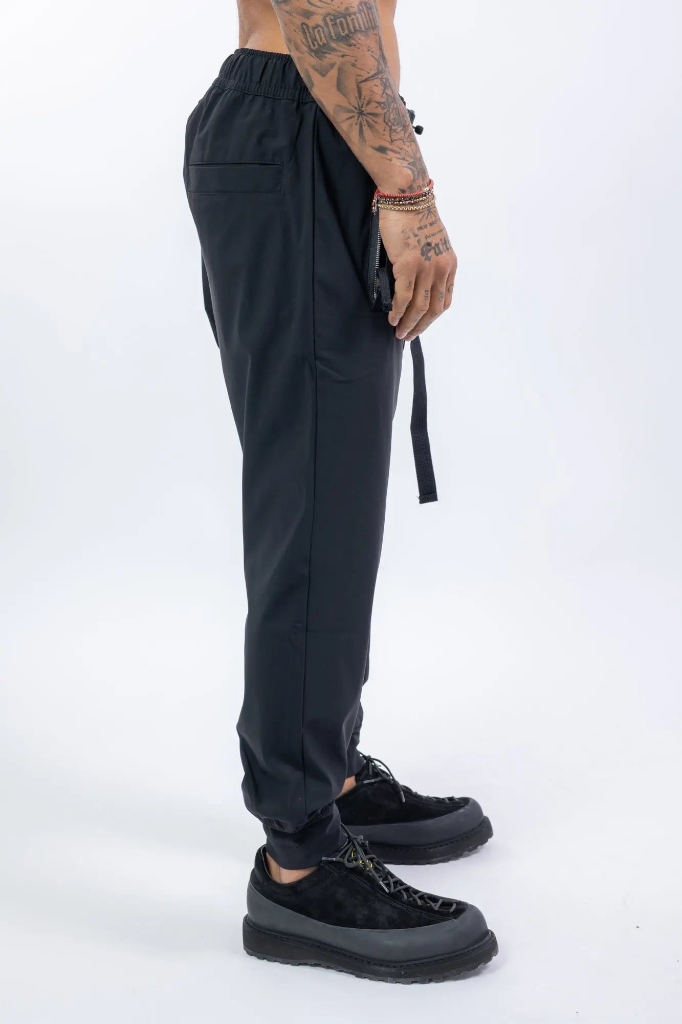 Thom Krom,Mens Trousers,Black,Low Crotch,Integrated Cinch Belt At Waistband,Front Zip Pockets,Back Welt And Cargo Pockets,Concealed Safety Pocket,Power Evo Stretch Fabric,Profile Photo