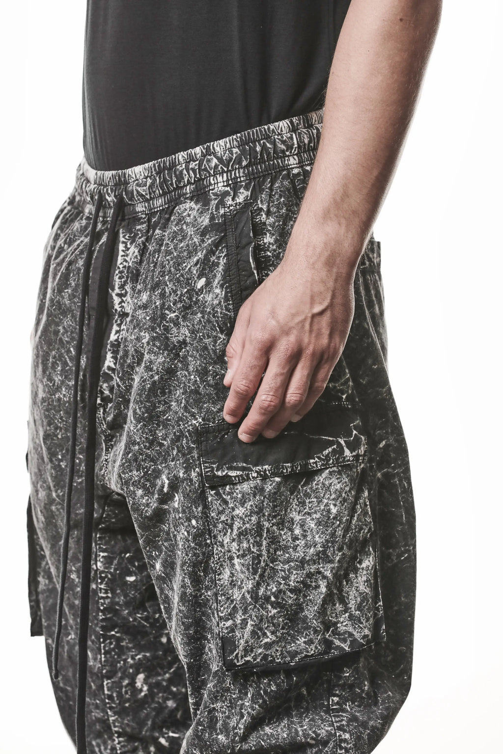 Thom Krom, Mens Trousers, Black, Cargo Pants, Zip Pockets, Side Pockets, Drawstring, Elasticated Waistband, Elasticated Ankle Cuffs, Drop-Crotch, Back Pockets, YKK Zippers, Front 3/4 Close-up View. 