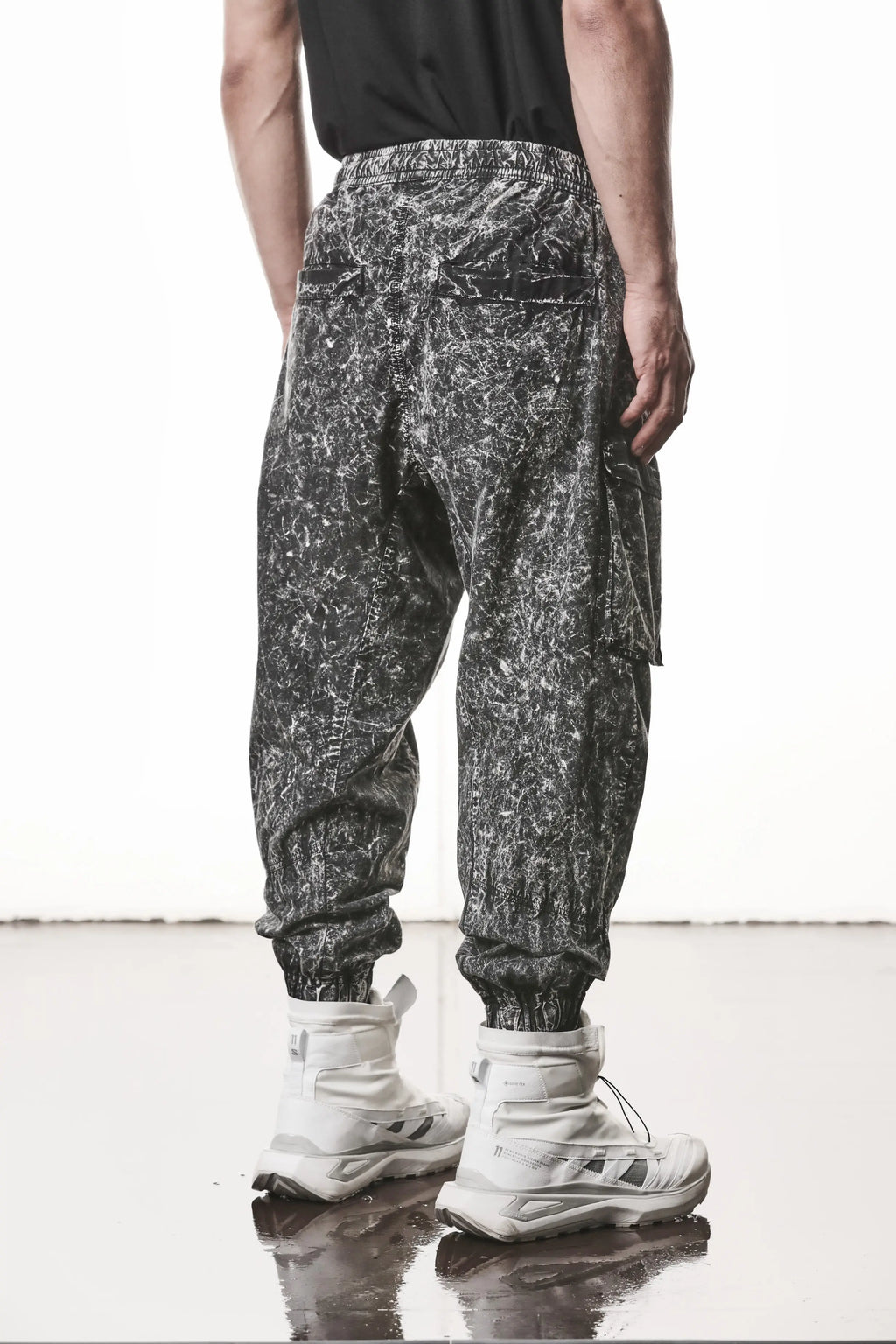 Thom Krom, Mens Trousers, Black, Cargo Pants, Zip Pockets, Side Pockets, Drawstring, Elasticated Waistband, Elasticated Ankle Cuffs, Drop-Crotch, Back Pockets, YKK Zippers, Back 3/4 View. 