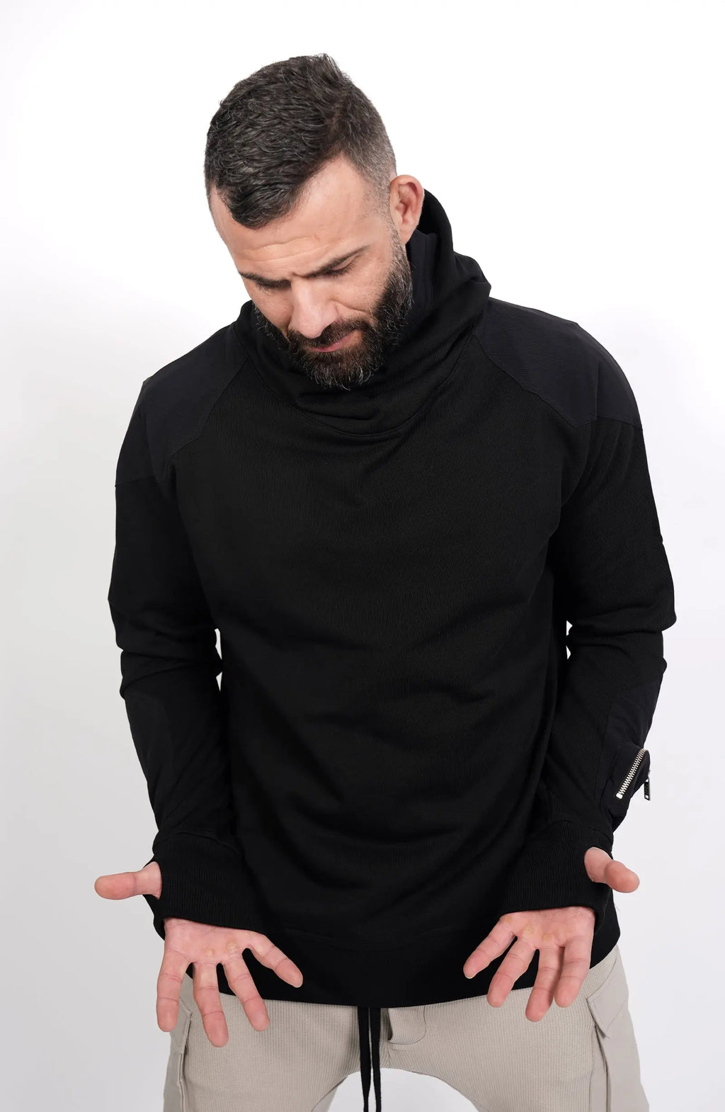 Thom Krom, Mens Hoodie, Black, Hooded Sweatshirt, Cotton, Stretch Nylon Inserts, Stretch Cotton Cuffs and Inserts, Cotton Jersey, Thumbholes, Mock Neck, Sleeve Zip Pocket, Front Looking at Hands View. 