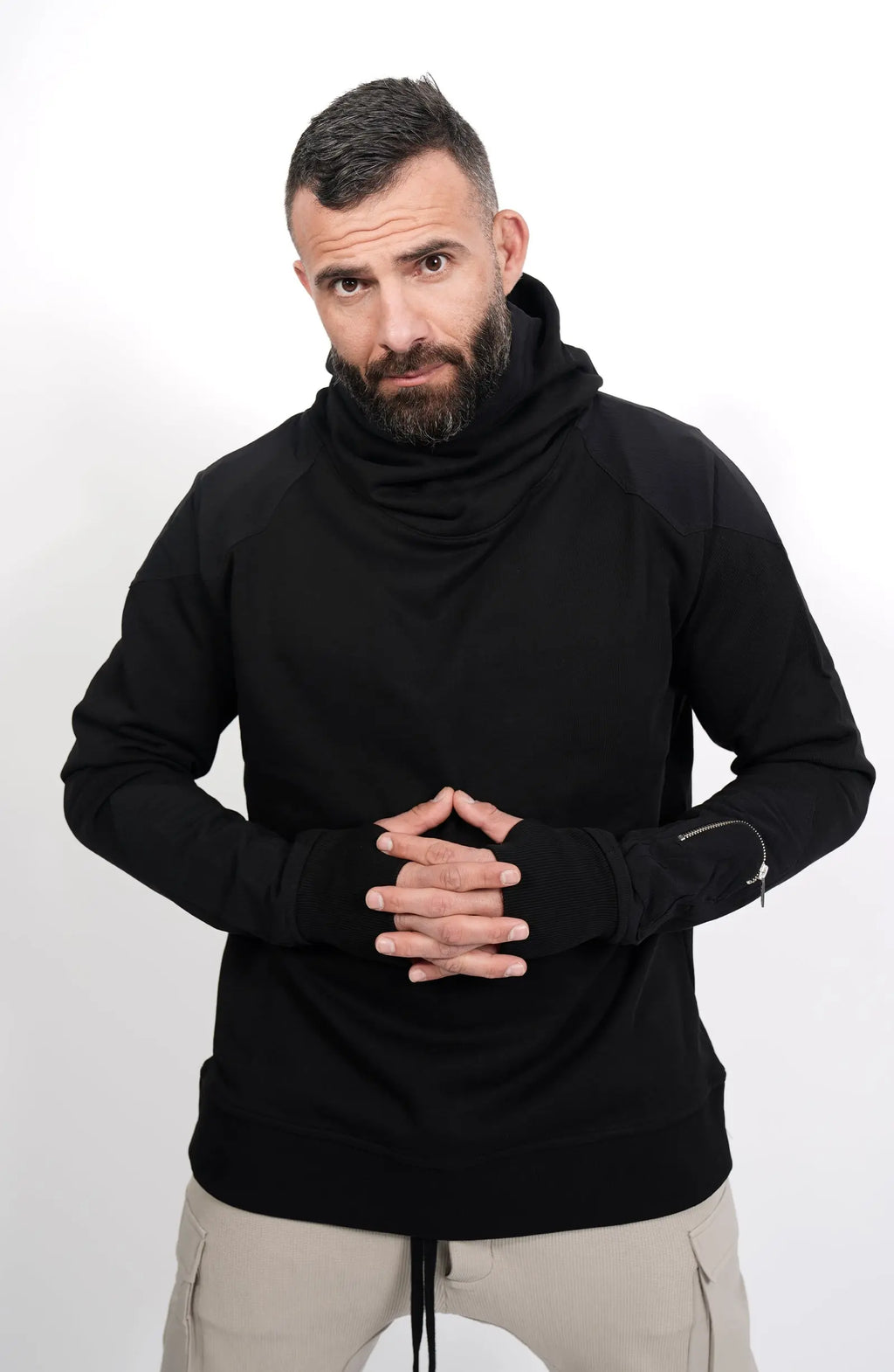 Thom Krom, Mens Hoodie, Black, Hooded Sweatshirt, Cotton, Stretch Nylon Inserts, Stretch Cotton Cuffs and Inserts, Cotton Jersey, Thumbholes, Mock Neck, Sleeve Zip Pocket, Front Portrait Looking at Camera. 
