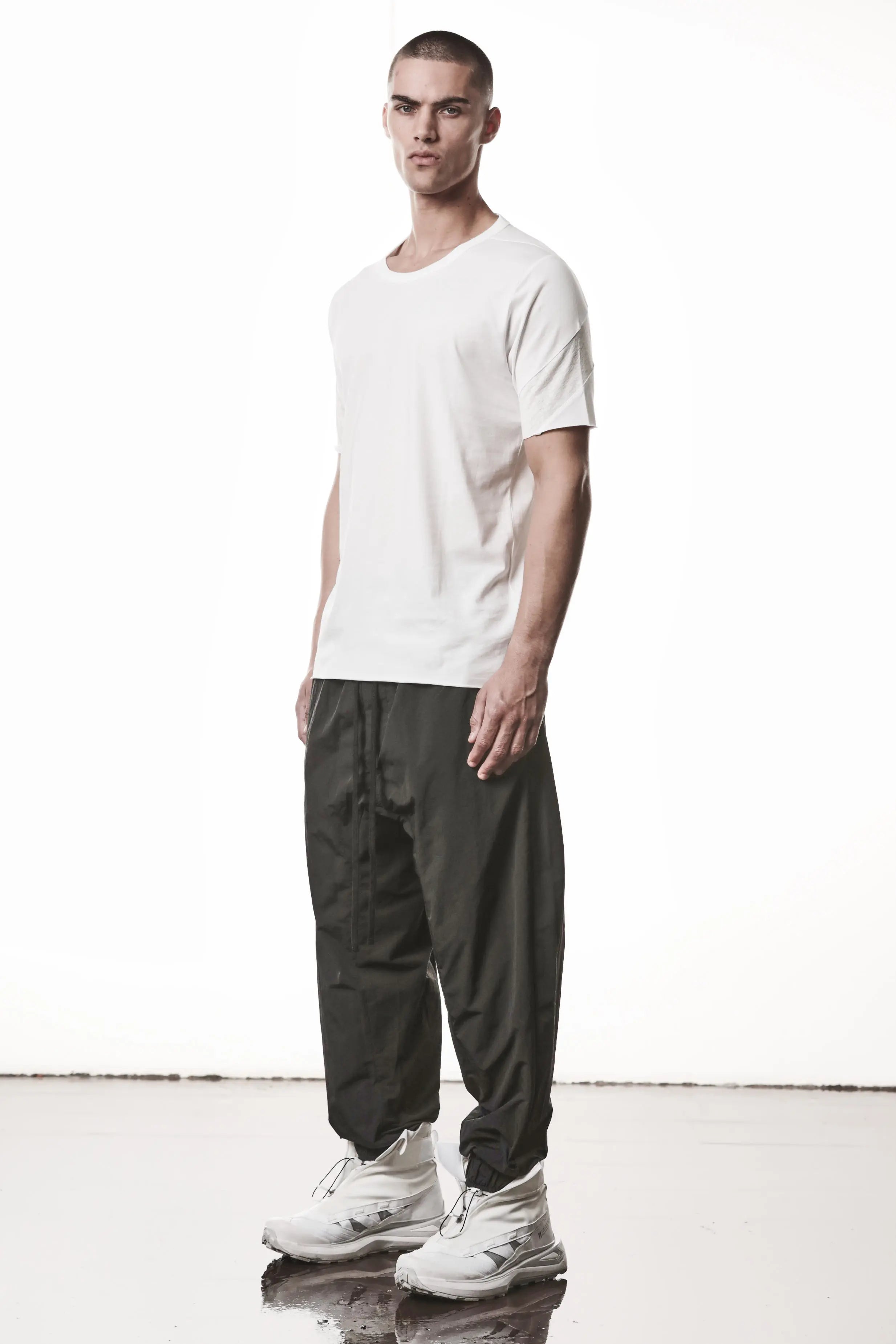 Thom Krom, Mens T-Shirt, White, Cotton Jersey with breathability Inserts, Viscose Linen Inserts, Crewneck, Short Sleeves, Lightweight, 100% Cotton, Signature Cross Black Seams, The Night is your friend, my love, Full Body 3/4 Front Photo. 