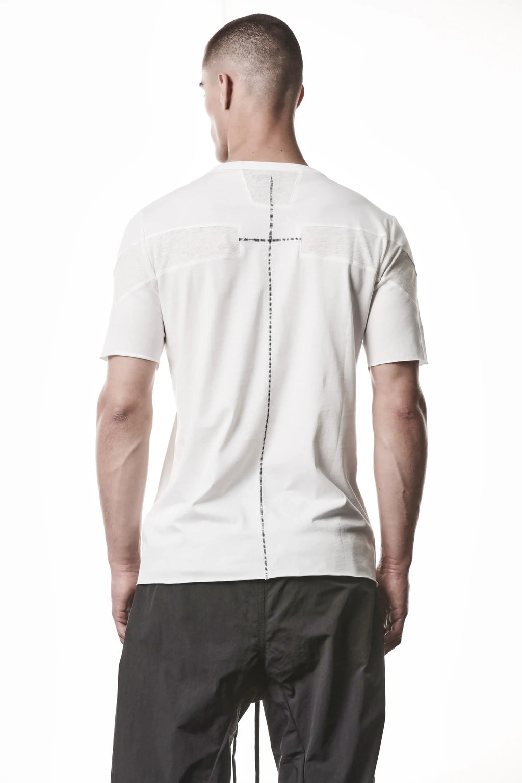 Thom Krom, Mens T-Shirt, White, Cotton Jersey with breathability Inserts, Viscose Linen Inserts, Crewneck, Short Sleeves, Lightweight, 100% Cotton, Signature Cross Black Seams, Back View. 