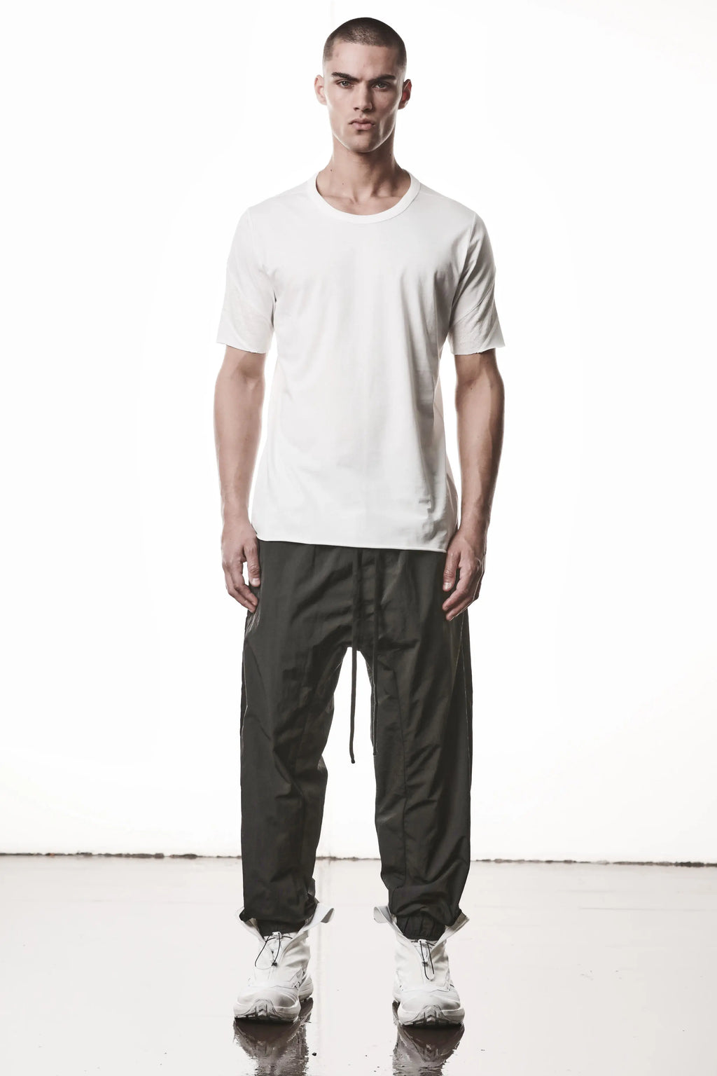 Thom Krom, Mens T-Shirt, White, Cotton Jersey with breathability Inserts, Viscose Linen Inserts, Crewneck, Short Sleeves, Lightweight, 100% Cotton, Signature Cross Black Seams, The Night is your friend, my love, Full Body Front View. 