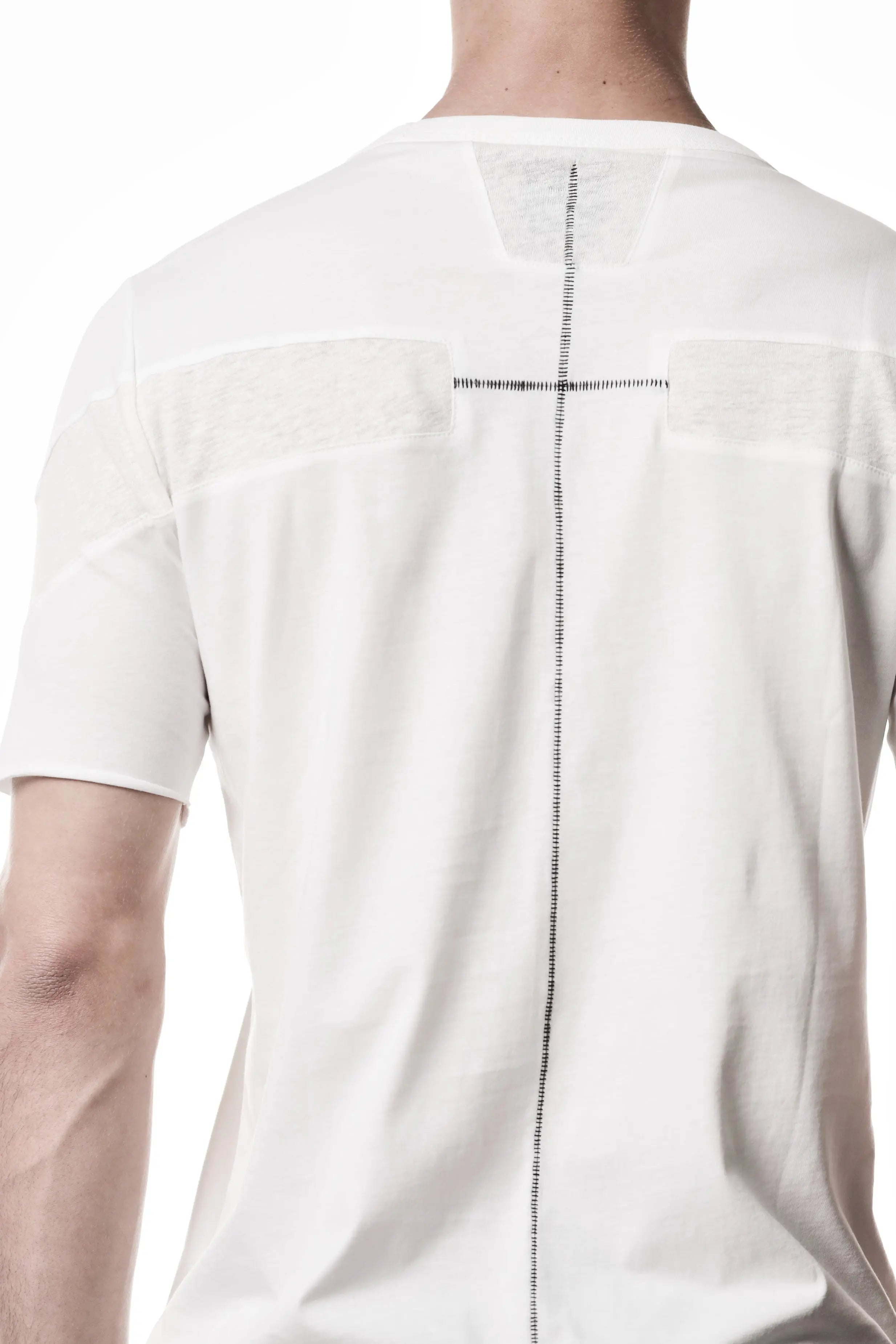 Thom Krom, Mens T-Shirt, White, Cotton Jersey with breathability Inserts, Viscose Linen Inserts, Crewneck, Short Sleeves, Lightweight, 100% Cotton, Signature Cross Black Seams, The Night is your friend, my love, Black Seams Close-up. 