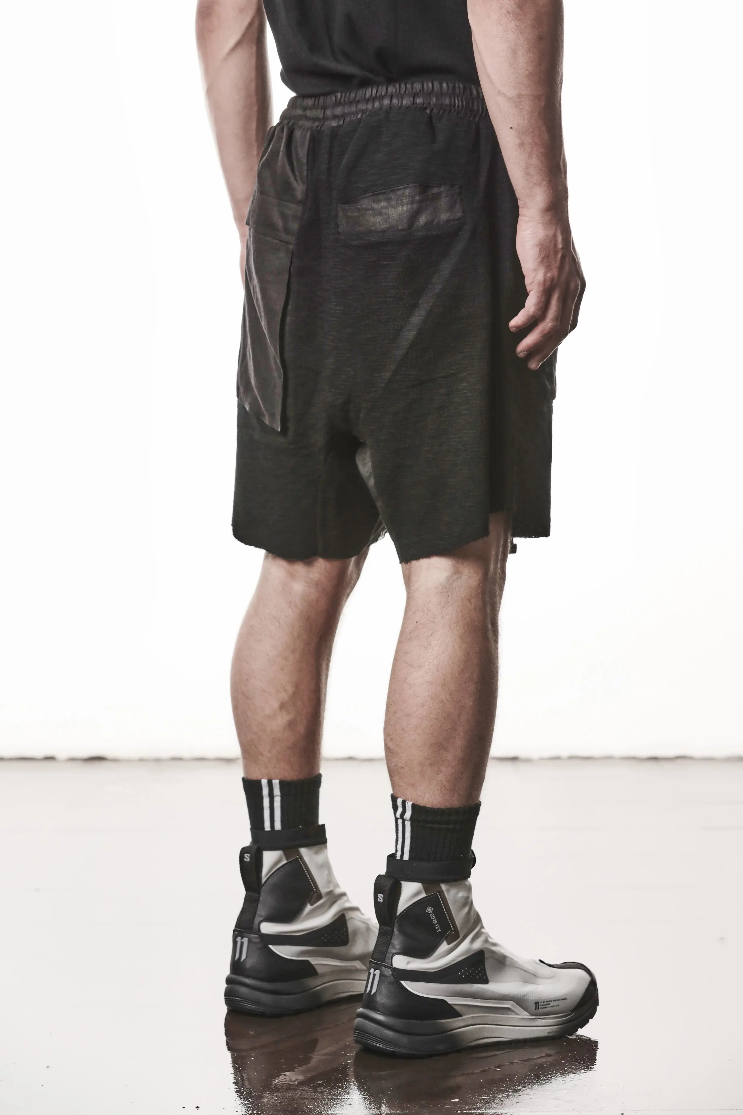 Thom Krom, Mens Shorts, Black, Hidden Zip Pockets, Elasticated Waistband, Linen Inserts, Drawstring, Side Pockets, Back Pockets, The night is your friend, my love, Back 3/4 View. 
