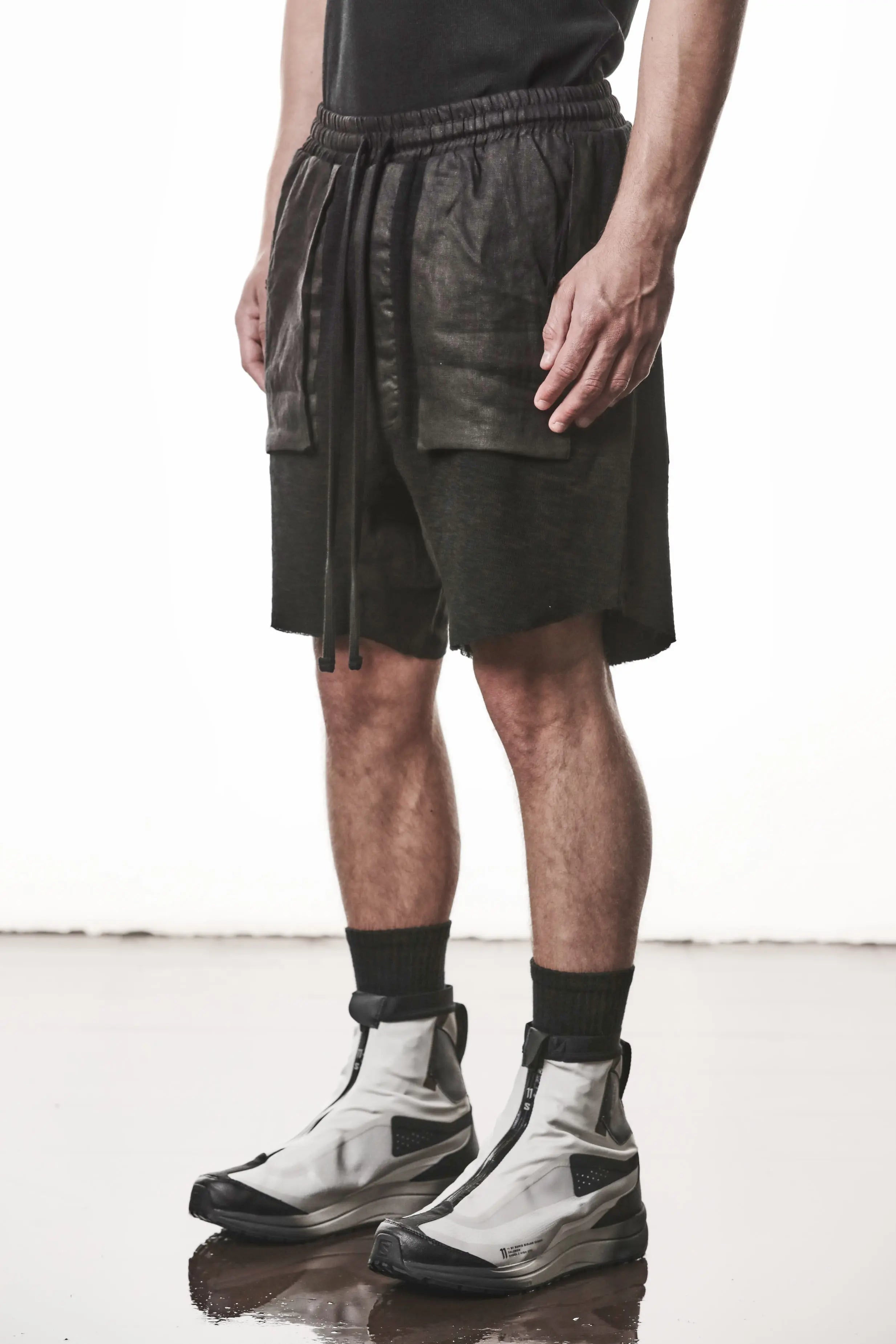 Thom Krom, Mens Shorts, Black, Hidden Zip Pockets, Elasticated Waistband, Linen Inserts, Drawstring, Side Pockets, Back Pockets, The night is your friend, my love, Front 3/4 View. 