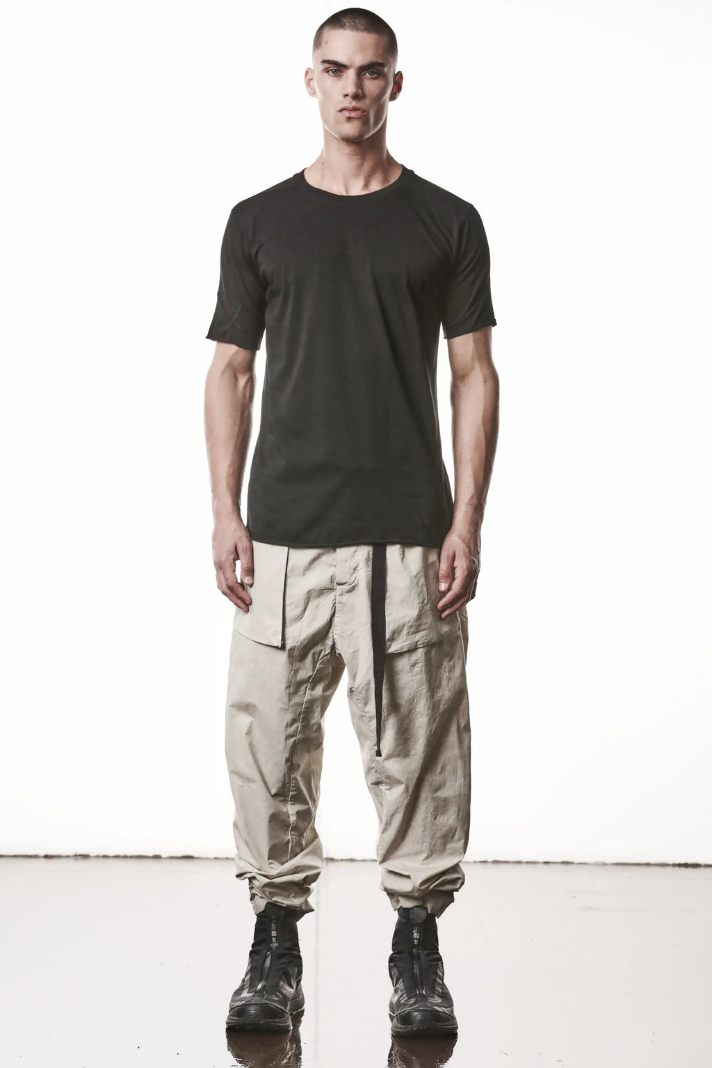 Thom Krom, Mens T-Shirt, Black, Raw-Cut Hem, Elastic Neck, 100% Cotton, Short Sleeves, Crewneck, Round Neck, White Cross Seams, Back Seams, Embroidered Logo, Full Body Front View. 