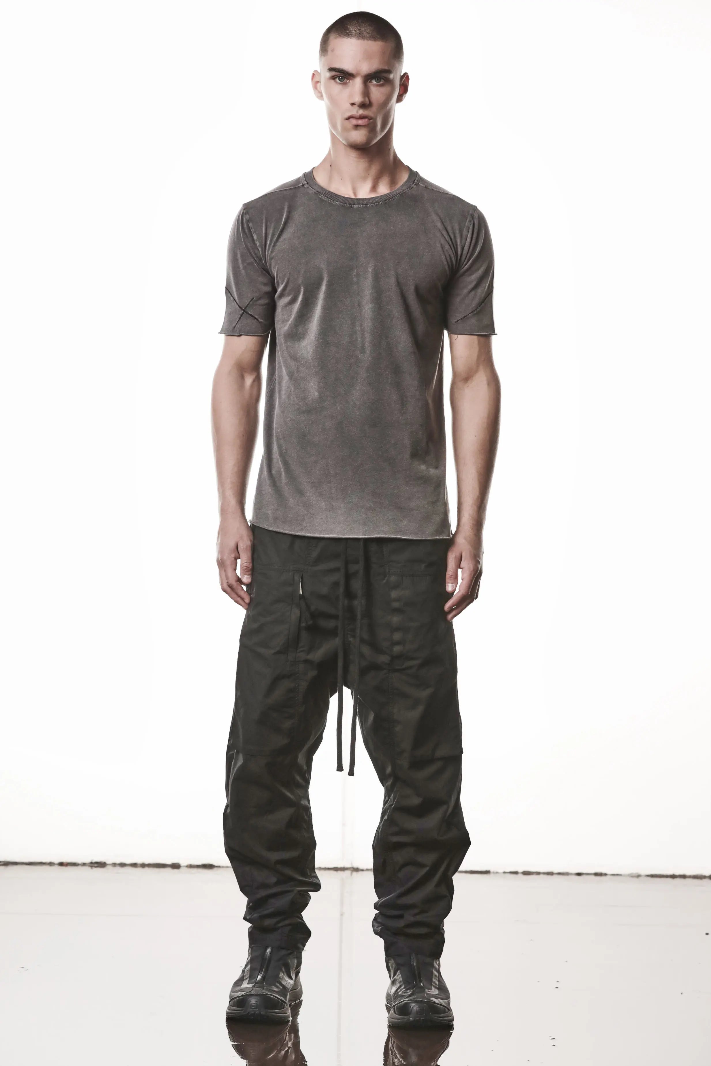 Thom Krom, Mens T-Shirt, Dark Used Grey, Raw-Cut Hem, Elastic Neck, 100% Cotton, Short Sleeves, Crewneck, Round Neck, Dark Seams, Back Seams, Embroidered Logo, Full Body Front View. 