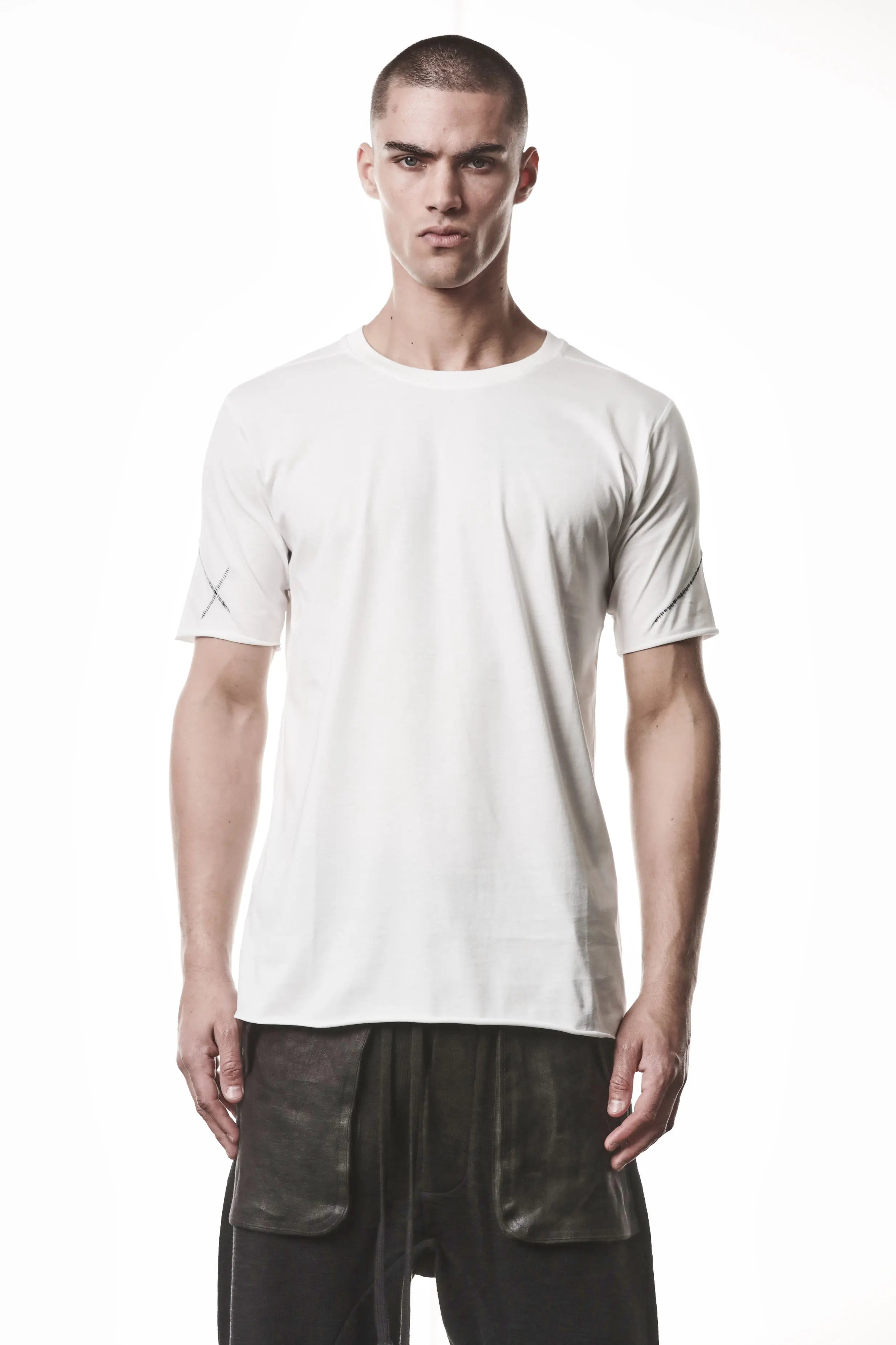Thom Krom, Mens T-Shirt, Off-White, Raw-Cut Hem, Elastic Neck, 100% Cotton, Short Sleeves, Crewneck, Round Neck, Dark Seams, Back Seams, Embroidered Logo, Front Portrait. 