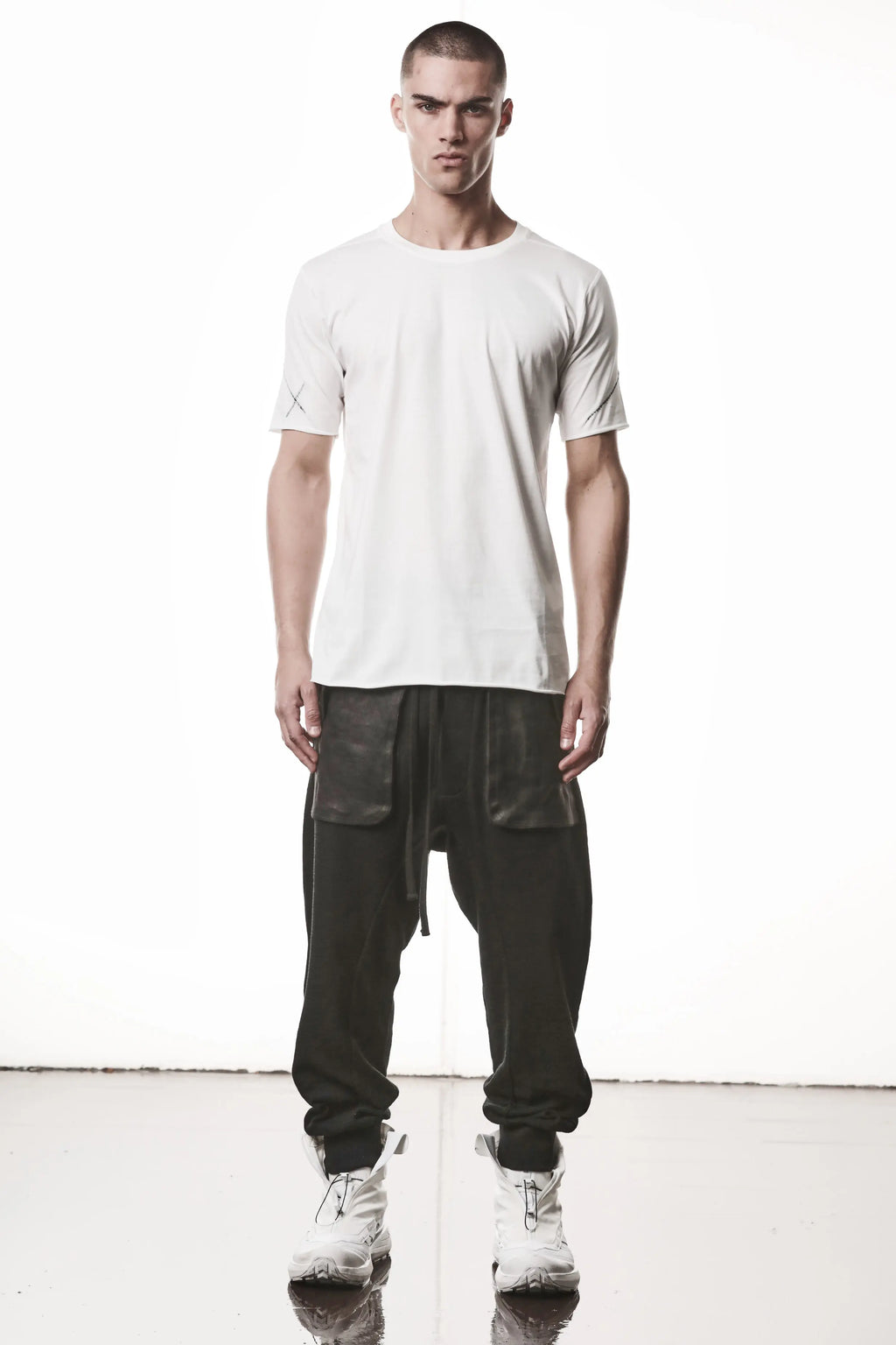 Thom Krom, Mens T-Shirt, Off-White, Raw-Cut Hem, Elastic Neck, 100% Cotton, Short Sleeves, Crewneck, Round Neck, Dark Seams, Back Seams, Embroidered Logo, Full Body Front View. 